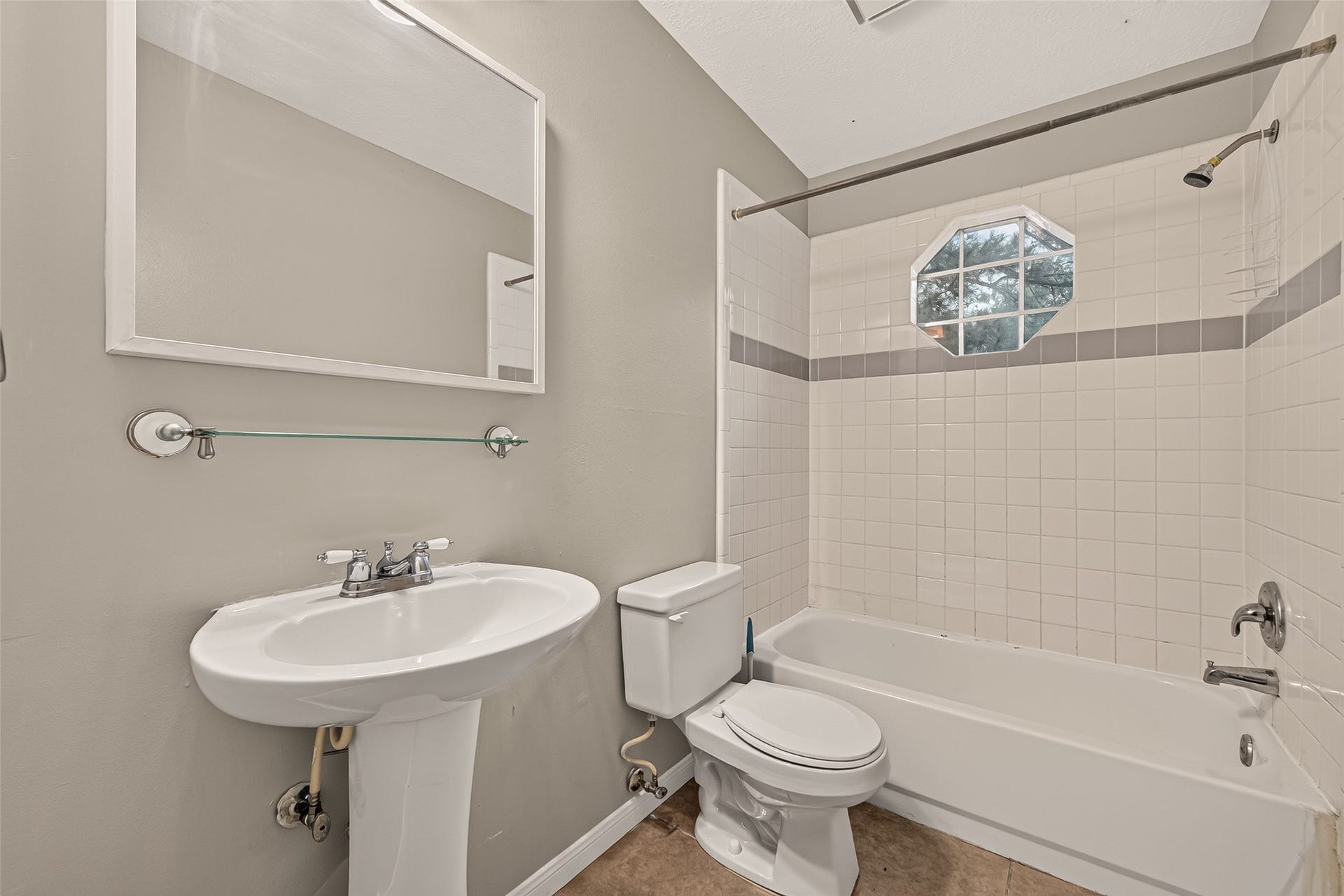 22818 Williamschase Drive, Katy, TX 77449 Second floor full bathroom featuring a pedestal sink, tiled tub and shower combination in neutral finishes