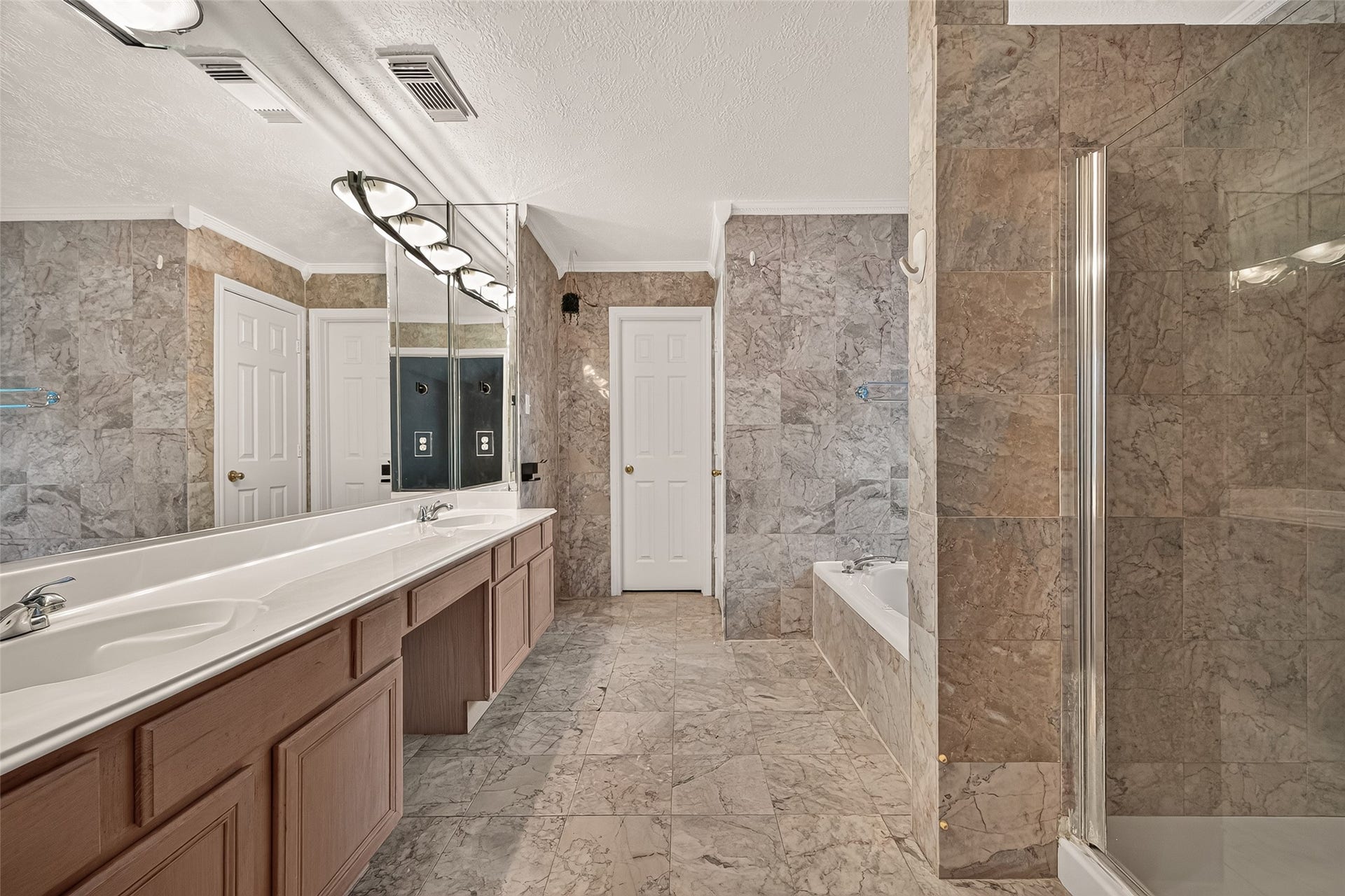 22818 Williamschase Drive, Katy, TX 77449 Spacious primary bathroom featuring a double sink vanity, Jacuzzi tub and a separate glass enclosed shower. A perfect retreat for relaxation and comfort