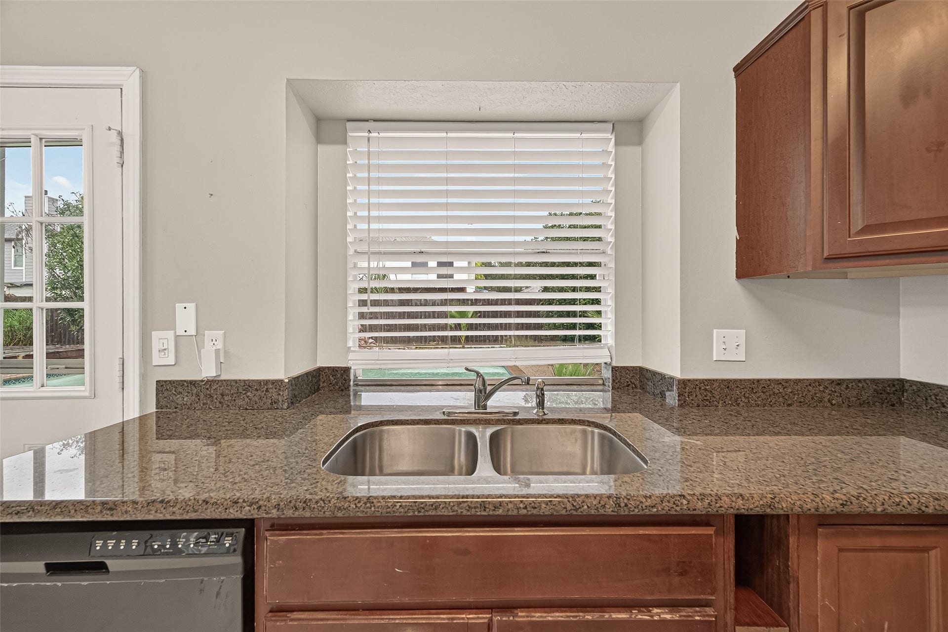 22818 Williamschase Drive, Katy, TX 77449 Double- basin stainless steel sink, granite countertops and a large window overlooking the pool