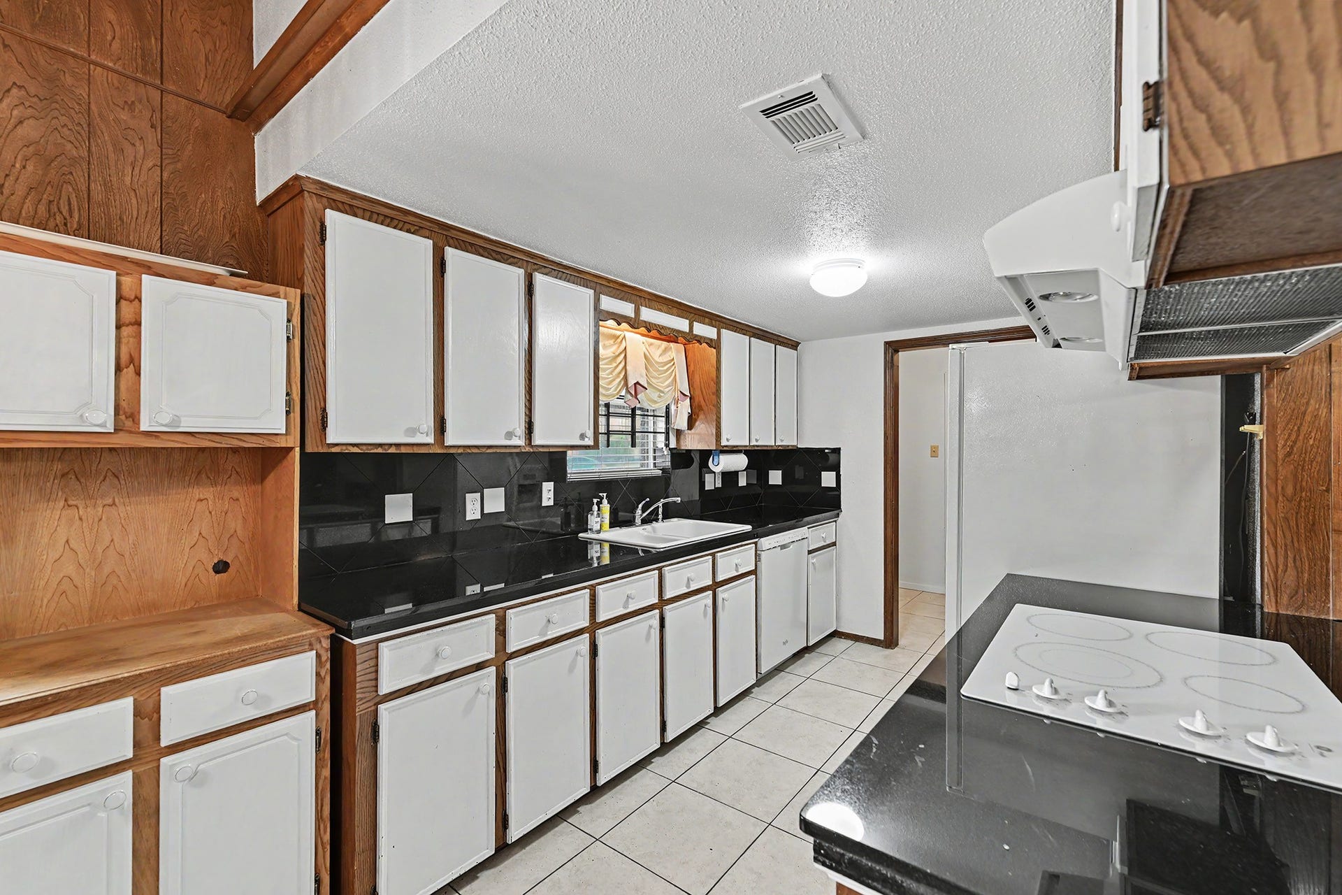 5403 Boots Road, Houston, TX 77091 Kitchen with granite countertops & electric cooktop/range