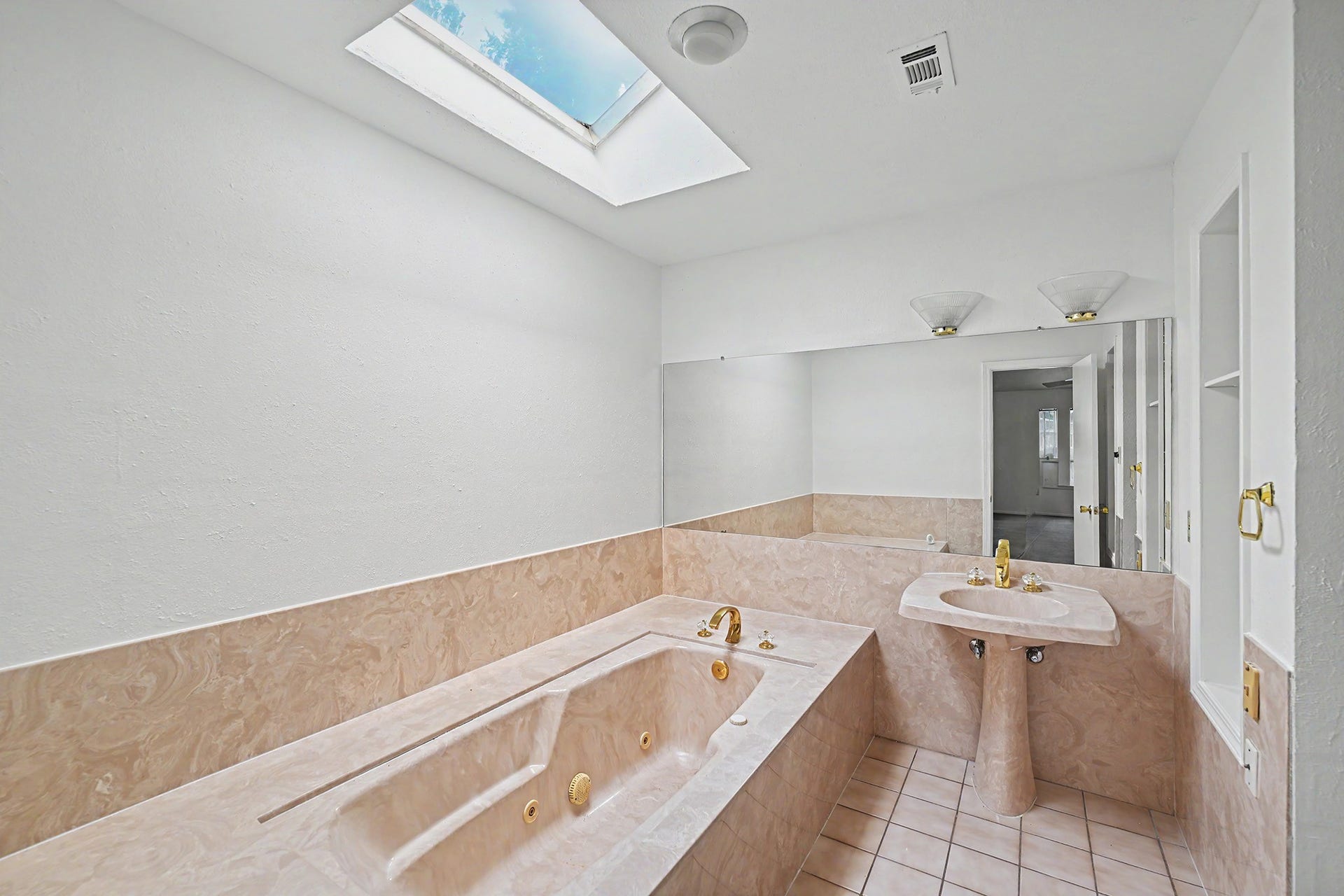 5403 Boots Road, Houston, TX 77091 Primary bathroom with HUGE jacuzzi tub and skylight providing natural light