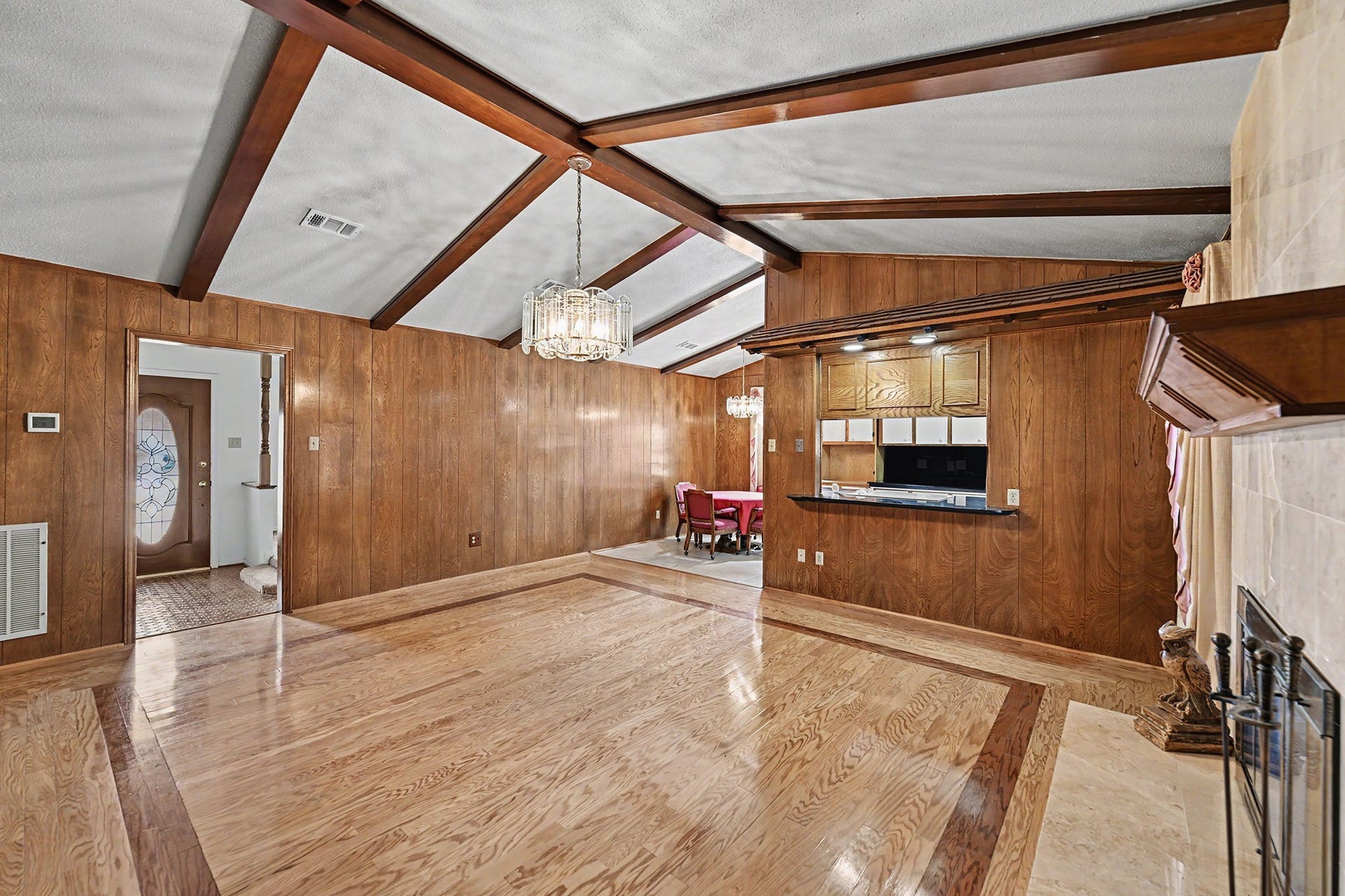 5403 Boots Road, Houston, TX 77091 Gleaming hardwood floors in living area with vaulted ceiling with wood beams