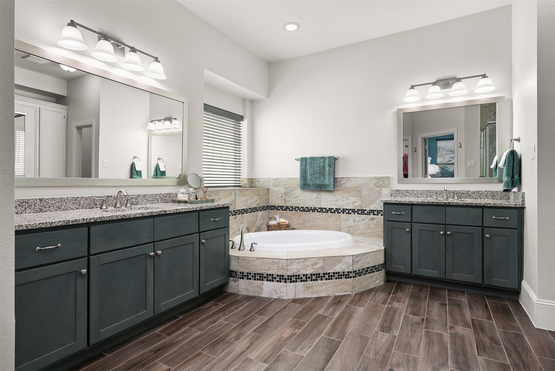 5418 Brigantine Cay Court, Texas City, TX 77590 Primary bath with two vanities, granite counters and custom tile work around the soaker tub.
