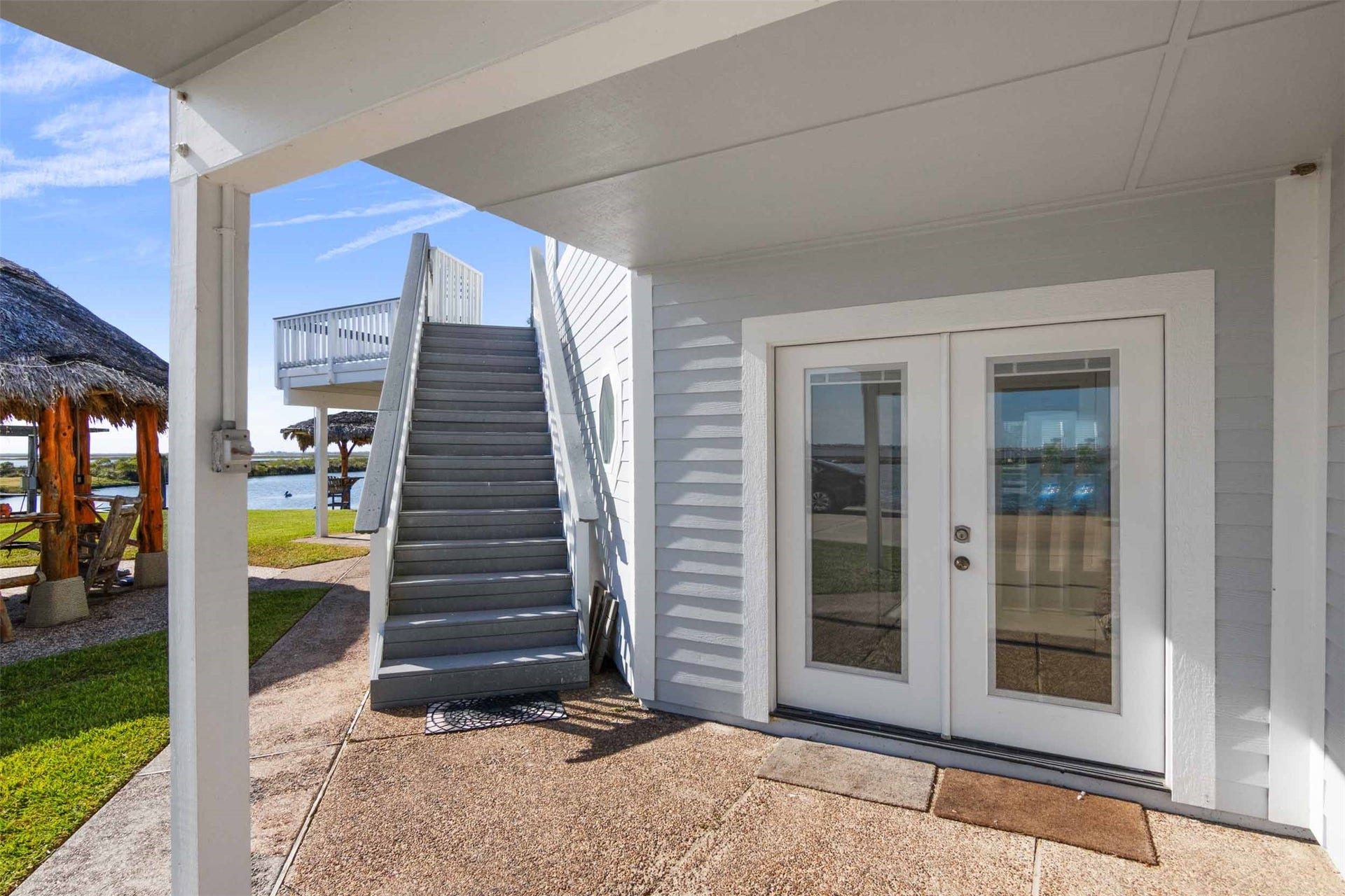 1318 Blue Heron Street, Bayou Vista, TX 77563 French doors into living area downstairs and outside stairs to second level.