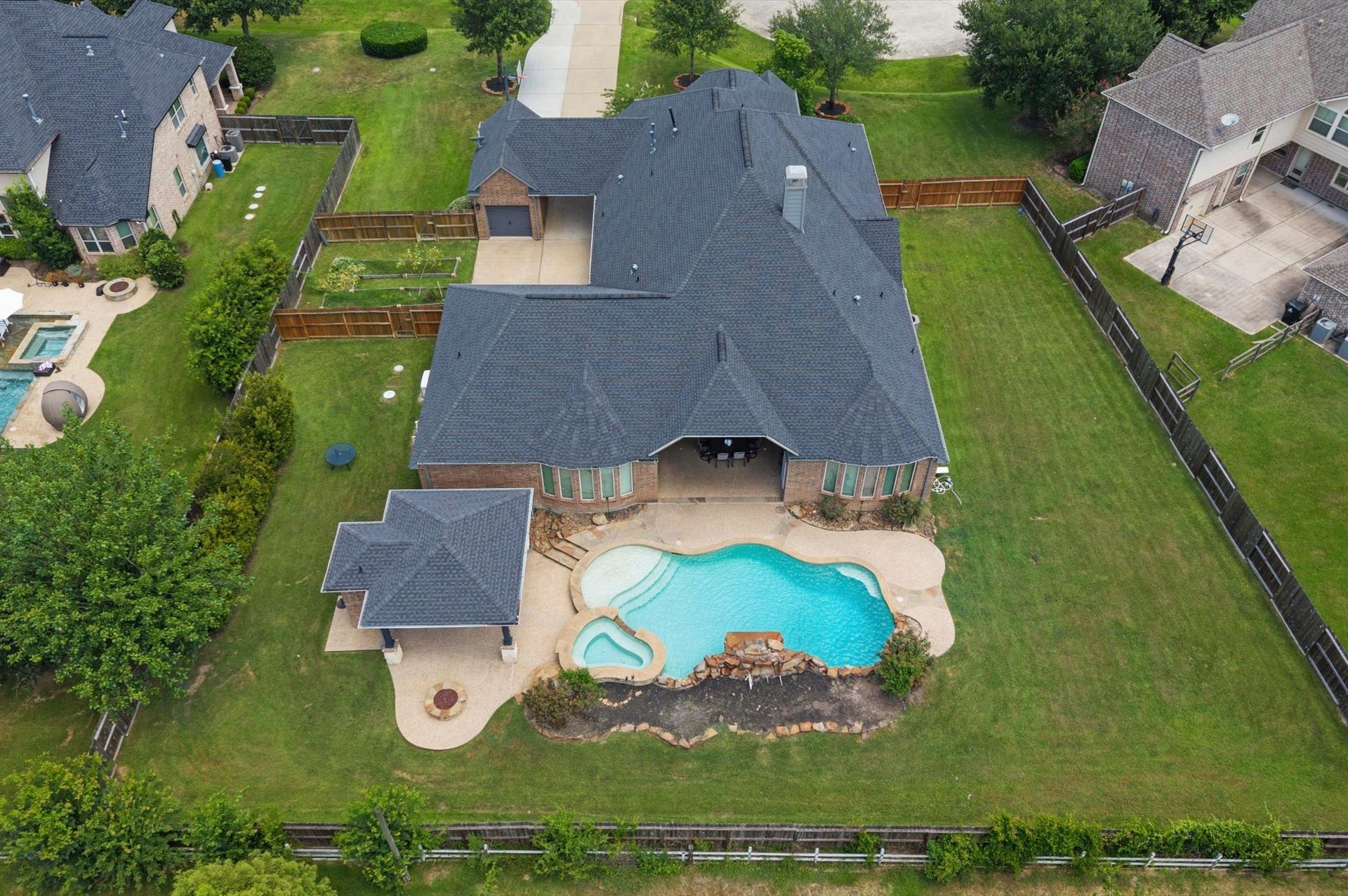 24611 Waterstone Estates Circle S, Tomball, TX 77375 The long side yard near the pool might be a great spot for play equipment or even a dog run.