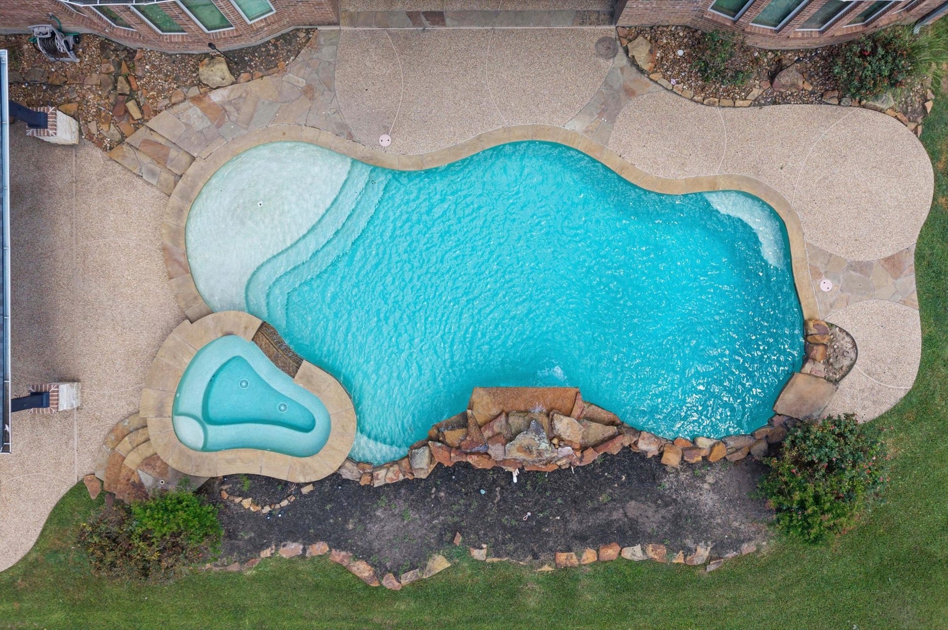 24611 Waterstone Estates Circle S, Tomball, TX 77375 An overhead view shows the space behind the waterfall to add your favorite foliage and colors.