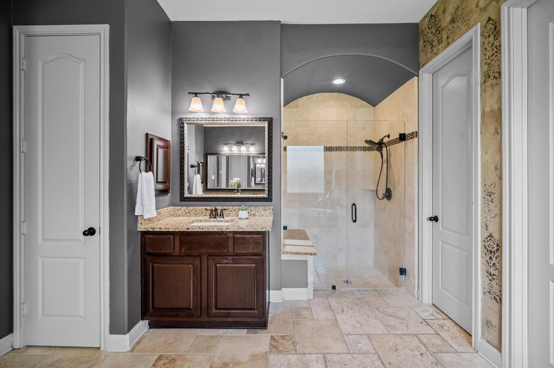 24611 Waterstone Estates Circle S, Tomball, TX 77375 The primary bath offers a frameless shower with a bench and separate vanity areas on one side.