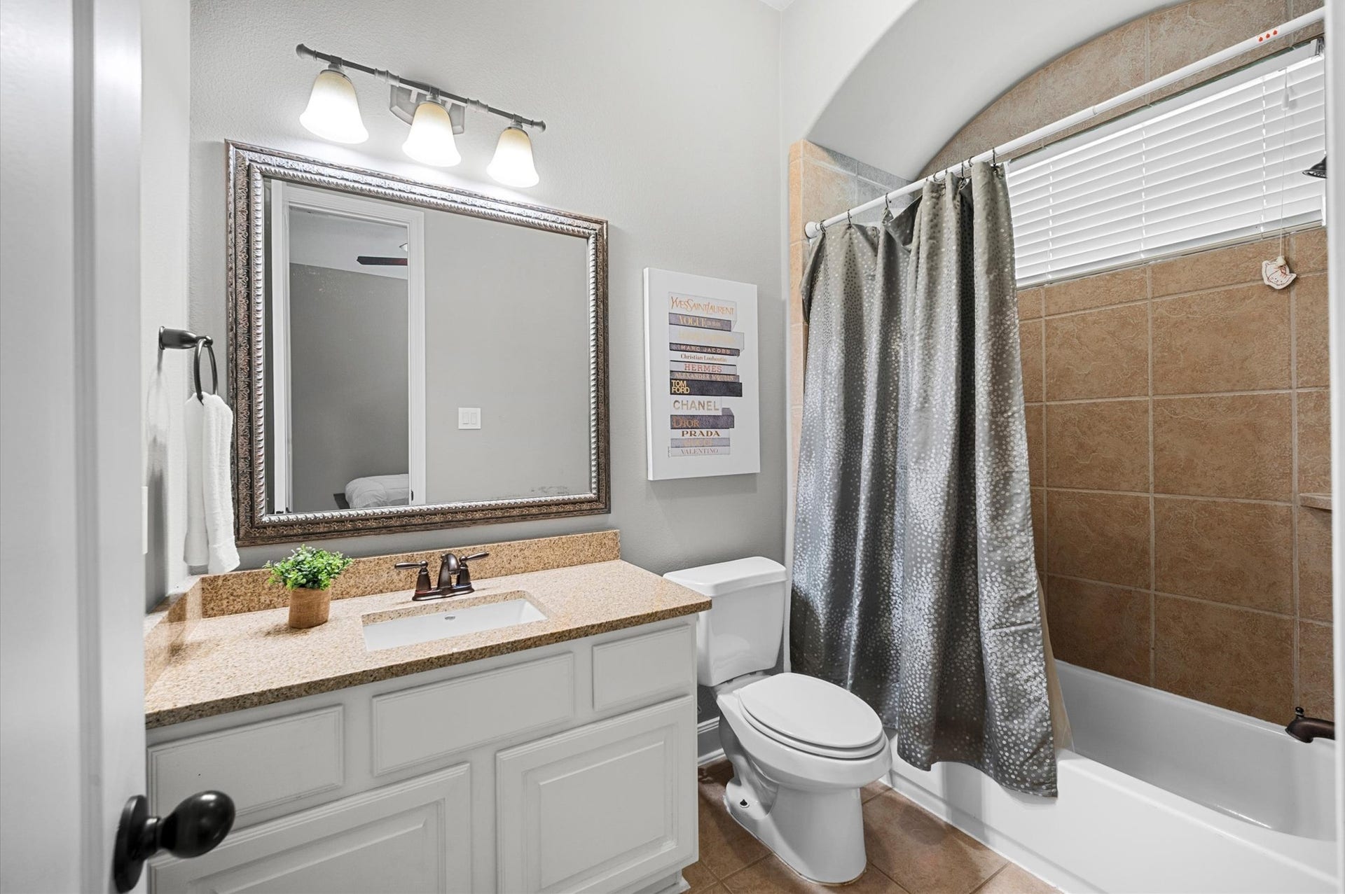 24611 Waterstone Estates Circle S, Tomball, TX 77375 The attached bathroom for Bedroom 2 features a tub and shower combination.