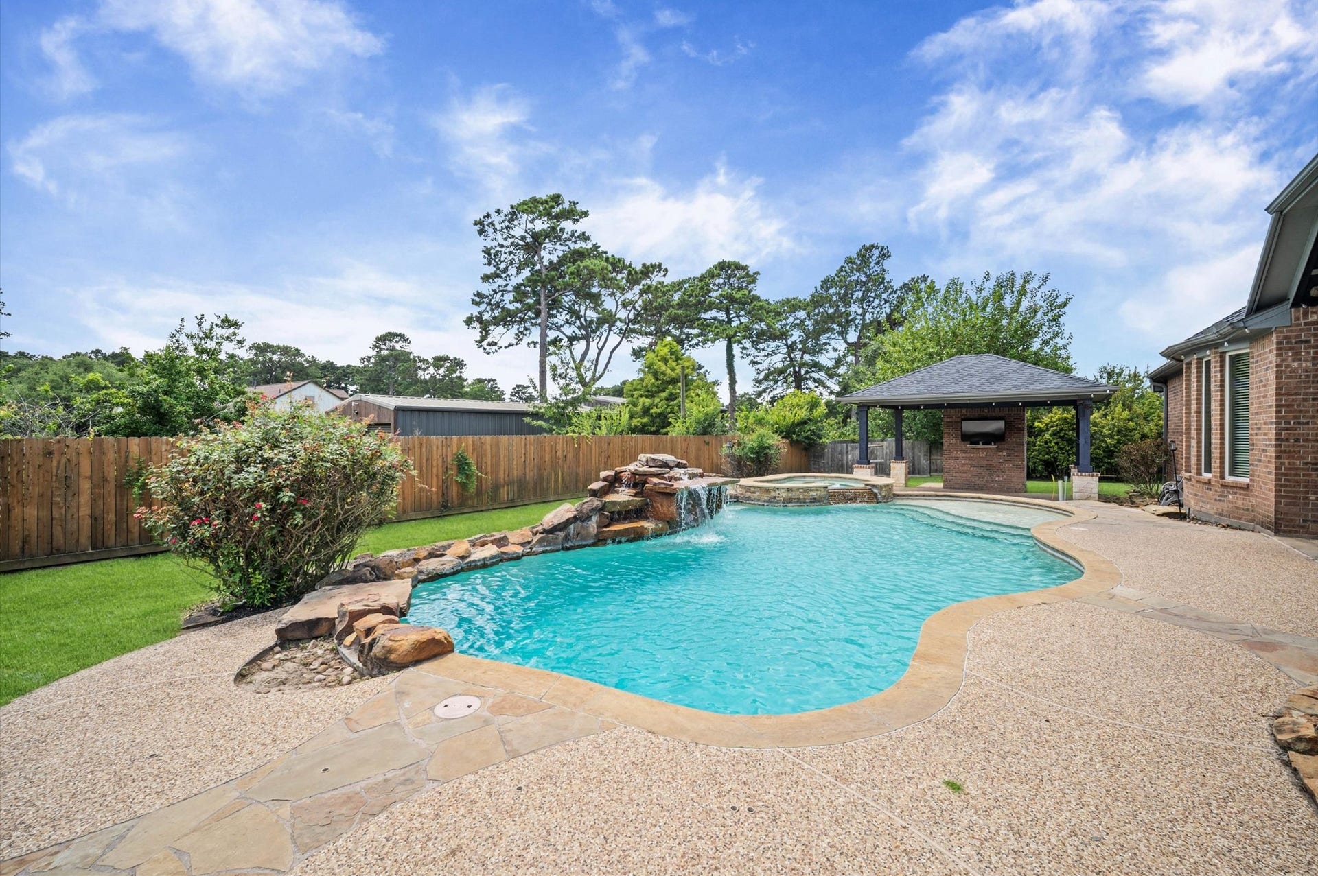 24611 Waterstone Estates Circle S, Tomball, TX 77375 Paradise awaits in this incredible backyard! Whether you sunbathe, relax in the shade, or take a refreshing swim, you'll love this private oasis.
