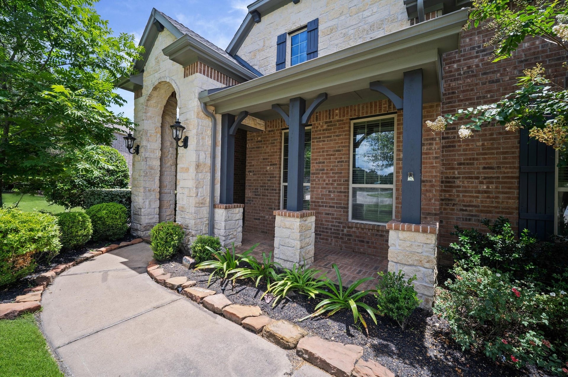 24611 Waterstone Estates Circle S, Tomball, TX 77375 Who doesn't love a covered front porch!? Add a few chairs and you'll have a shady spot to read your favorite book or welcome your visitors.