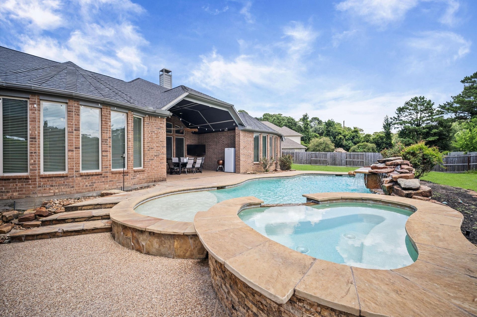 24611 Waterstone Estates Circle S, Tomball, TX 77375 This grand backyard still offers quite a bit of green space on either side of the home, perfect for playtime or pets.