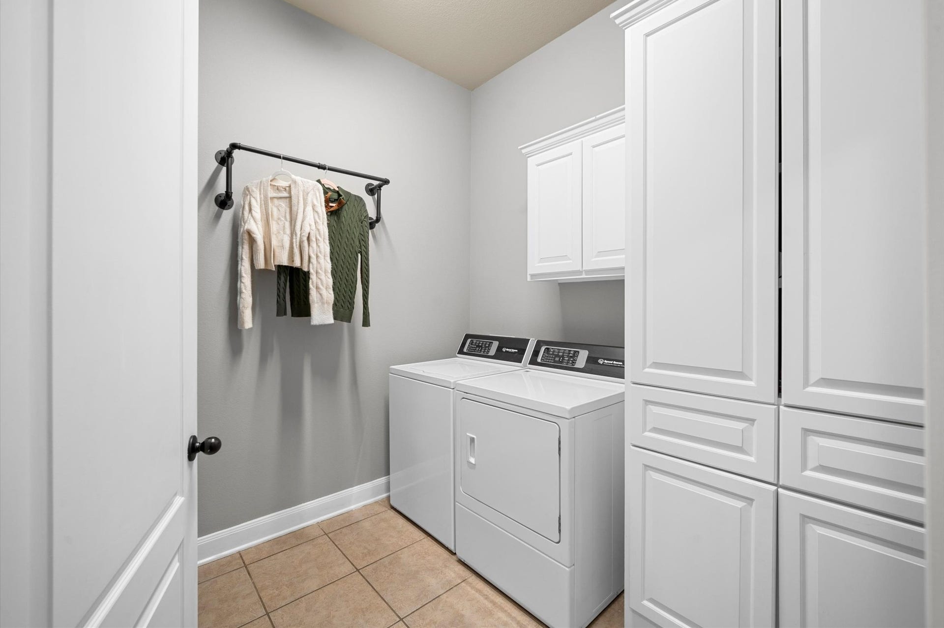 24611 Waterstone Estates Circle S, Tomball, TX 77375 A sizable utility room complete with built-in cabinets and plenty of space for a full-sized washer and dryer.