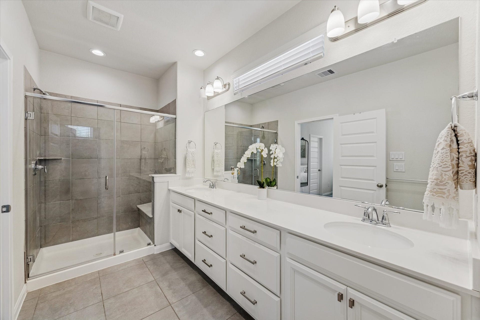 Luxury meets practicality with dual vanities and quality finishes.