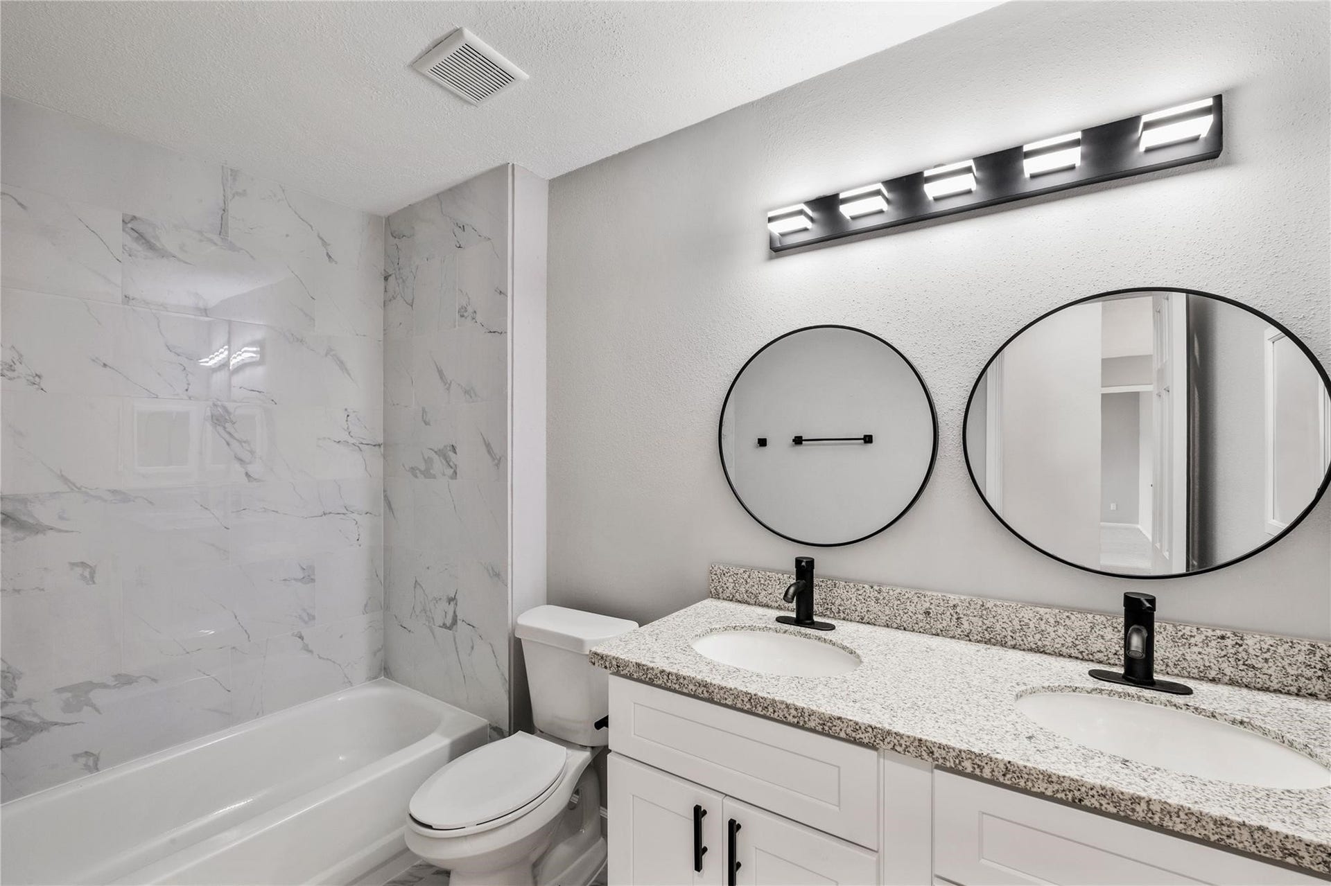 4523 Waterfall Way, Sugar Land, TX 77479 The upstairs shared bathroom features a granite vanity, updated fixtures, and a tub/shower combination with modern finishes.