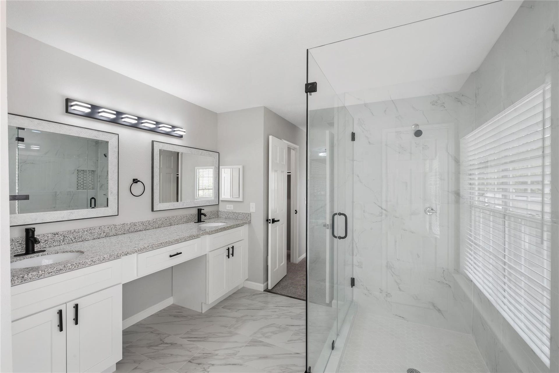 4523 Waterfall Way, Sugar Land, TX 77479 The spa-inspired primary bathroom showcases a frameless glass walk-in shower, dual vanities, and modern finishes throughout.