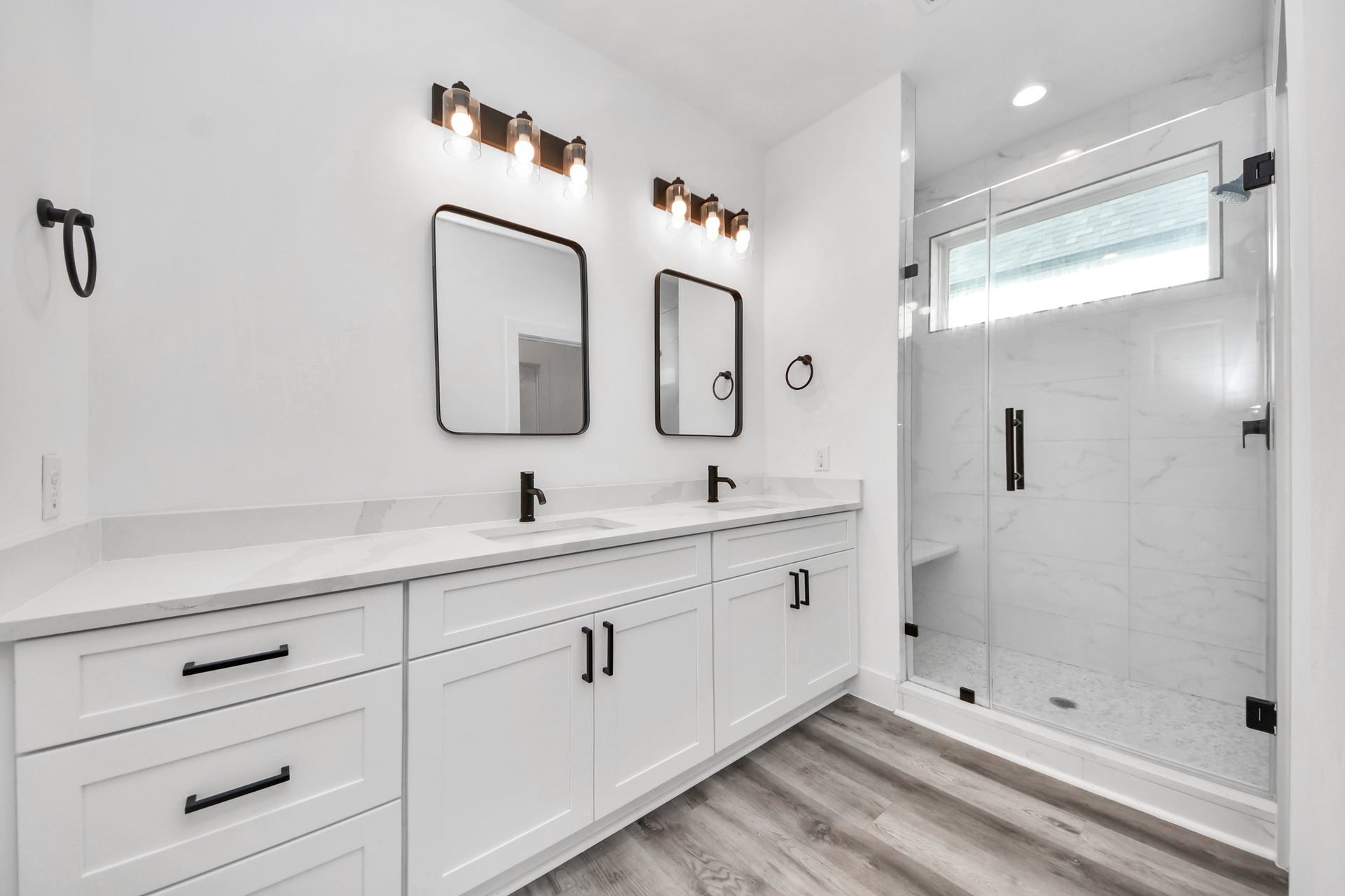 Primary bathroom with dual sinks and walk in shower.