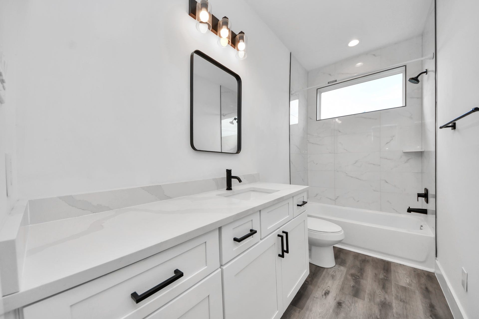 Upstairs full bathroom with plenty of vanity space.