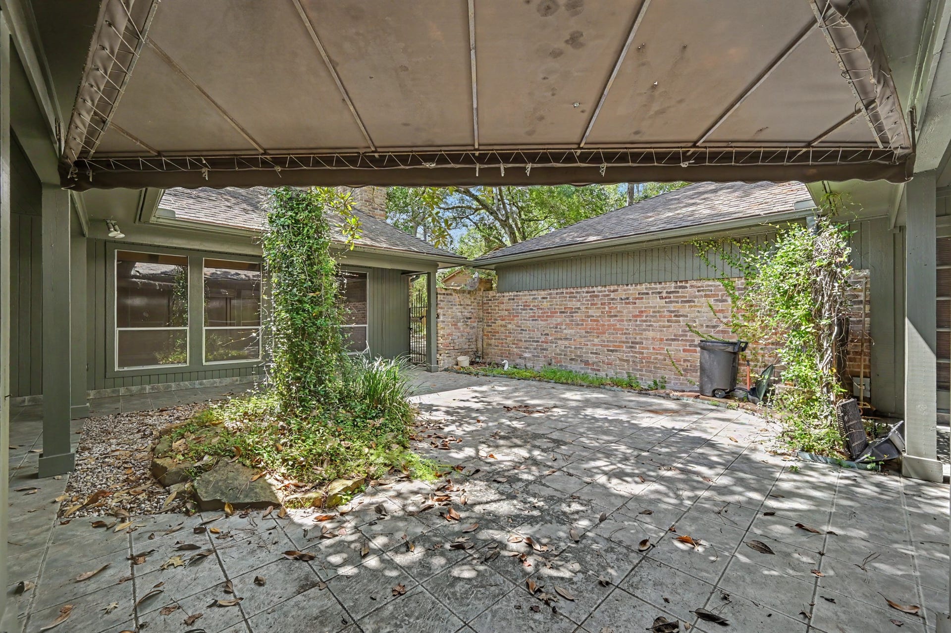 2710 N Logrun Circle, The Woodlands, TX 77380 The courtyard offers quite of bit of additional space that can be used for outdoor entertaining.