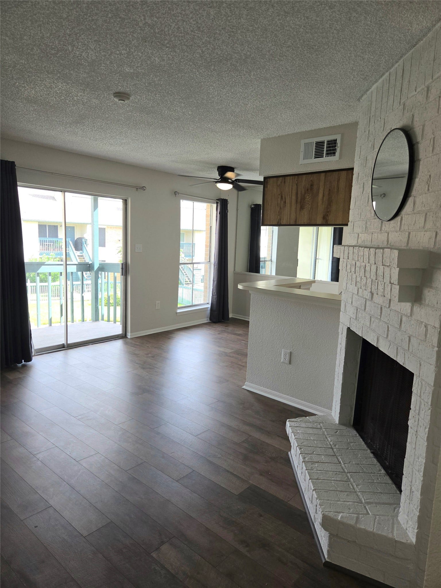 living room with fireplace and pool view