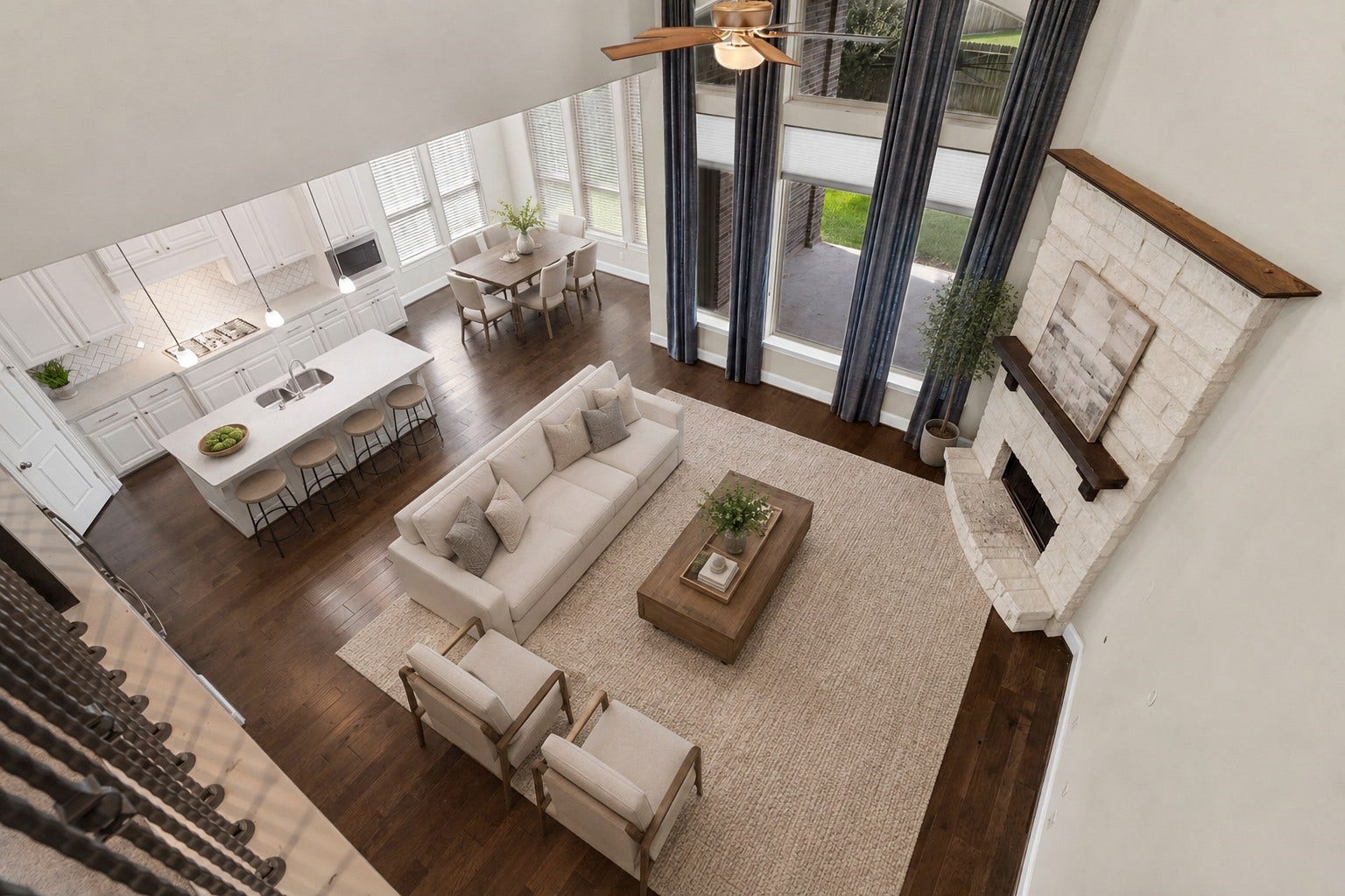 9410 Mount Logan, Missouri City, TX 77459 The home's exceptional open-concept design, where the soaring two-story family room, floor-to-ceiling stone fireplace, gourmet kitchen, and sunlit breakfast area flow together seamlessly. Expansive windows flood the space with natural light, creating a bright, inviting setting ideal for both everyday living and effortless entertaining.