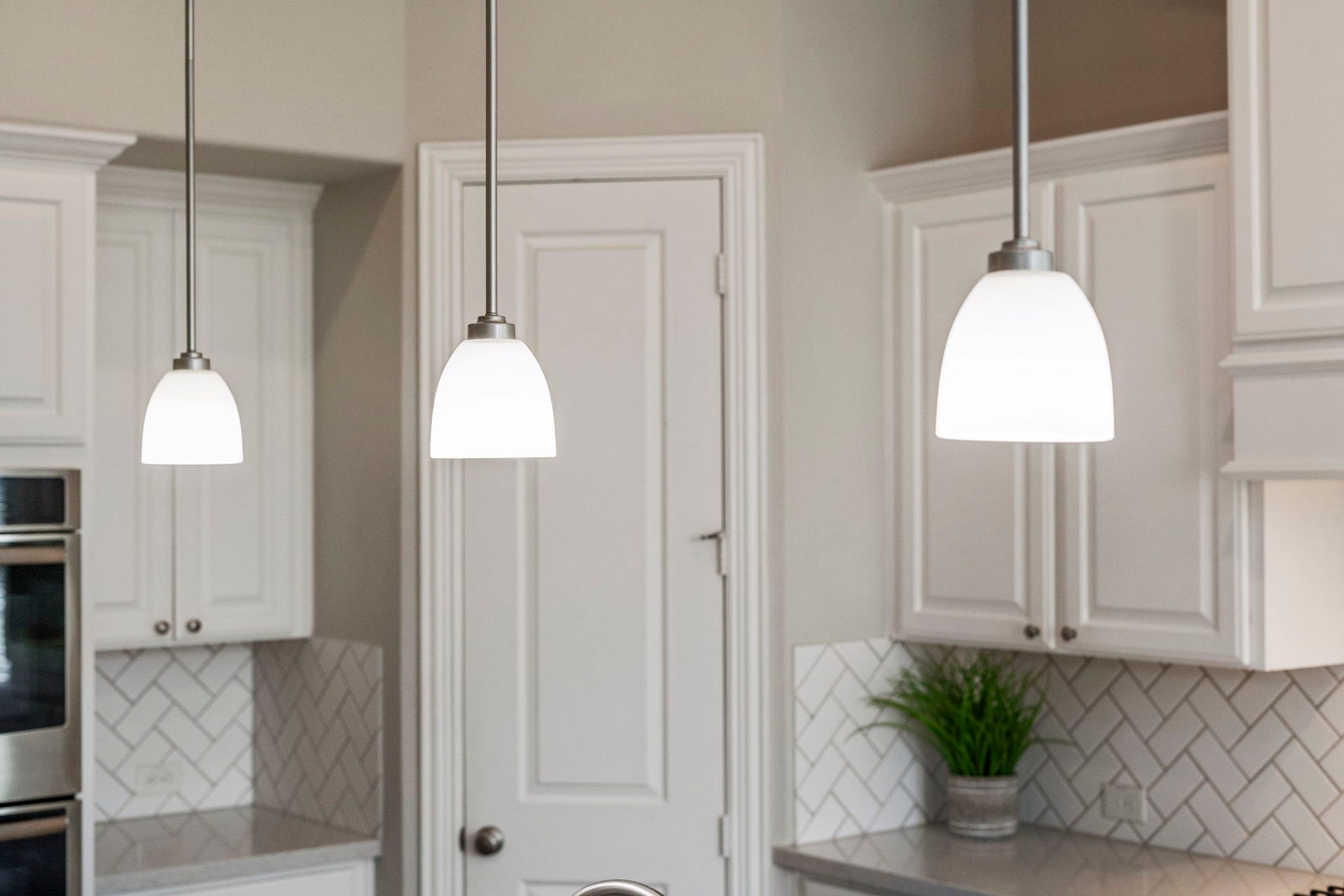 9410 Mount Logan, Missouri City, TX 77459 Designer pendant lighting adds character and sophistication to the kitchen.