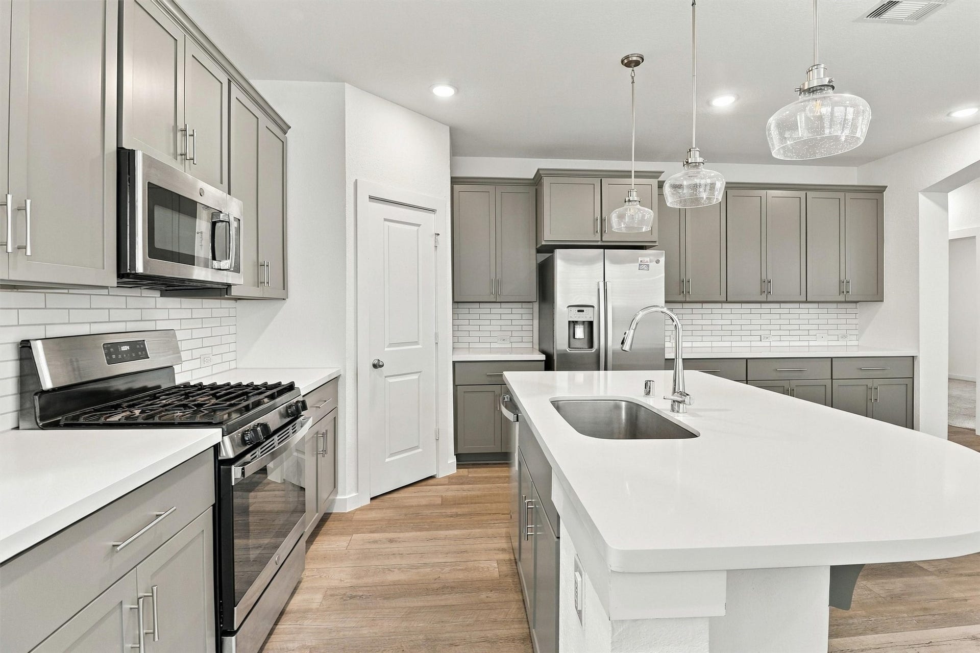 13109 Blue Flora Drive, Texas City, TX 77568 This gourmet kitchen has it all! The owner just refinished all of the cabinetry (9/2026) with new paint and soft close doors. This kitchen also features pendant lighting, stainless steel appliances, gas range, microwave, dishwasher, subway tile backsplash, and large island for cooking and entertaining!
