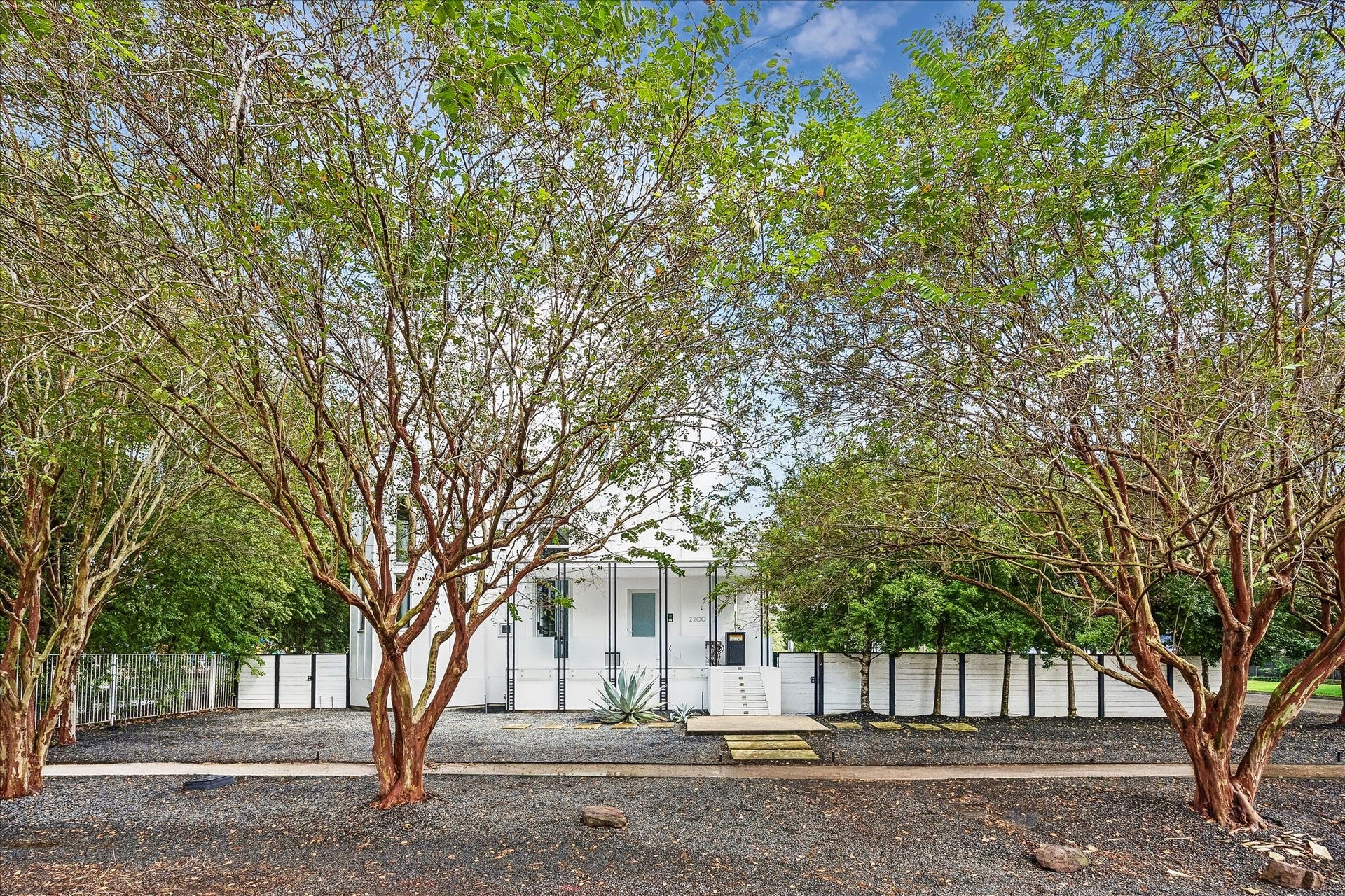 2200 Harvard Street, Houston, TX 77008 Located in the heart of the Heights, the Maison Blanche is a distinctive contemporary home that sits on three lots next to a serene park. Pictured here is a view of the entire house and the fenced-in, oversized pool area.