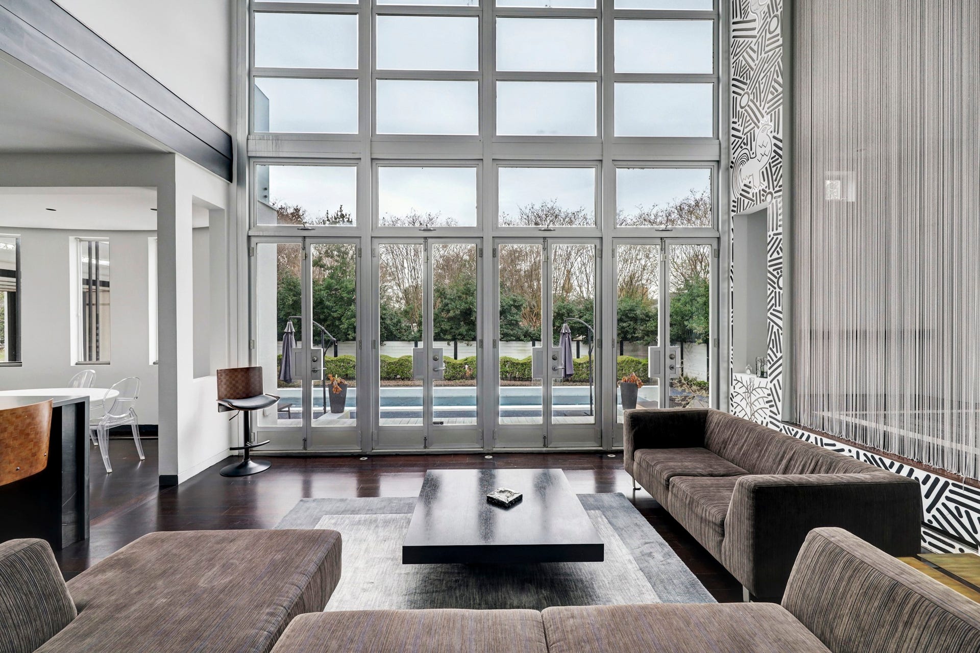 2200 Harvard Street, Houston, TX 77008 A wonderful space to entertain or cozy up with family. This living space features a one of a kind mural and floor to ceiling windows, allowing the natural light to flood within. Multiple double doors allow easy access to your private backyard retreat.