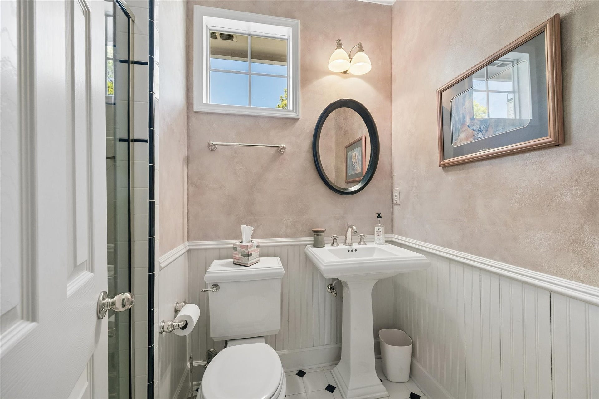 15106 Chestnut Glen Lane, Cypress, TX 77429 An additional full bathroom adds convenience and flexibility to the spacious addition above the garage. Tucked away for convenience, this charming bathroom features classic wainscoting, a pedestal sink, and a separate shower.