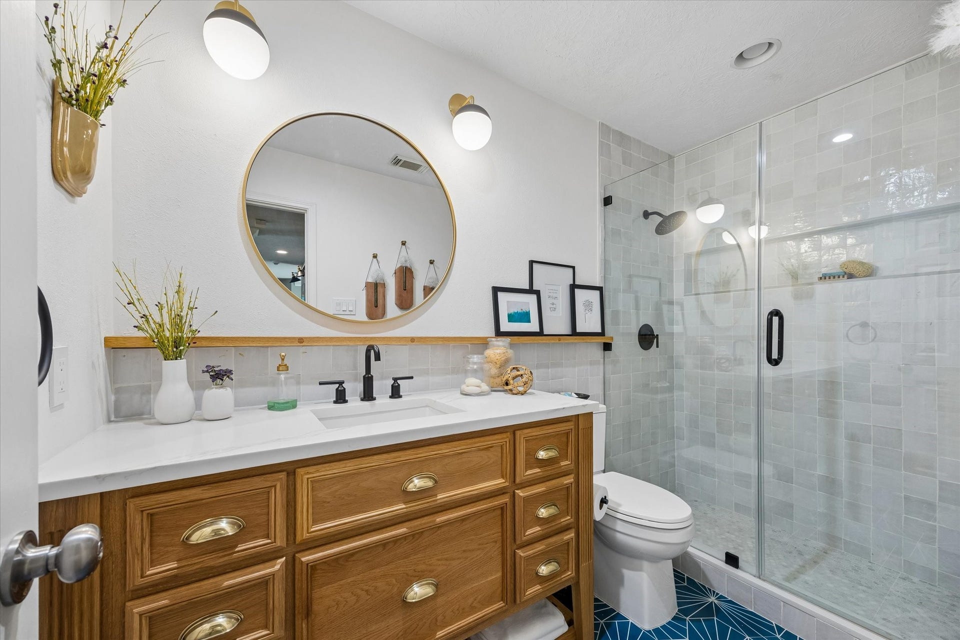15106 Chestnut Glen Lane, Cypress, TX 77429 Thoughtfully updated with attractive tilework, a seamless glass shower, and a spacious custom vanity, this bathroom combines everyday convenience with stylish finishes that complement the home's custom details.