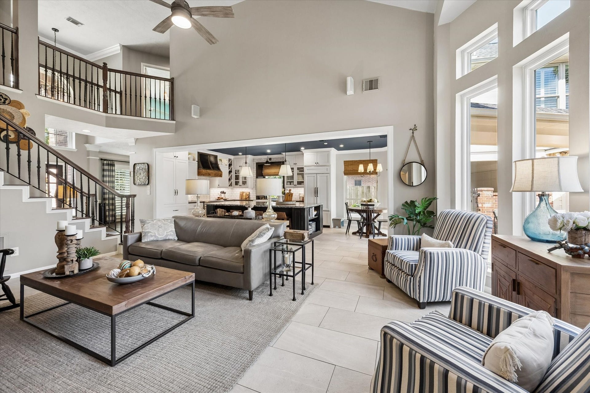 15106 Chestnut Glen Lane, Cypress, TX 77429 Dramatic ceiling heights, expansive windows, and an open view to the upstairs landing create an airy atmosphere while keeping the living spaces connected.