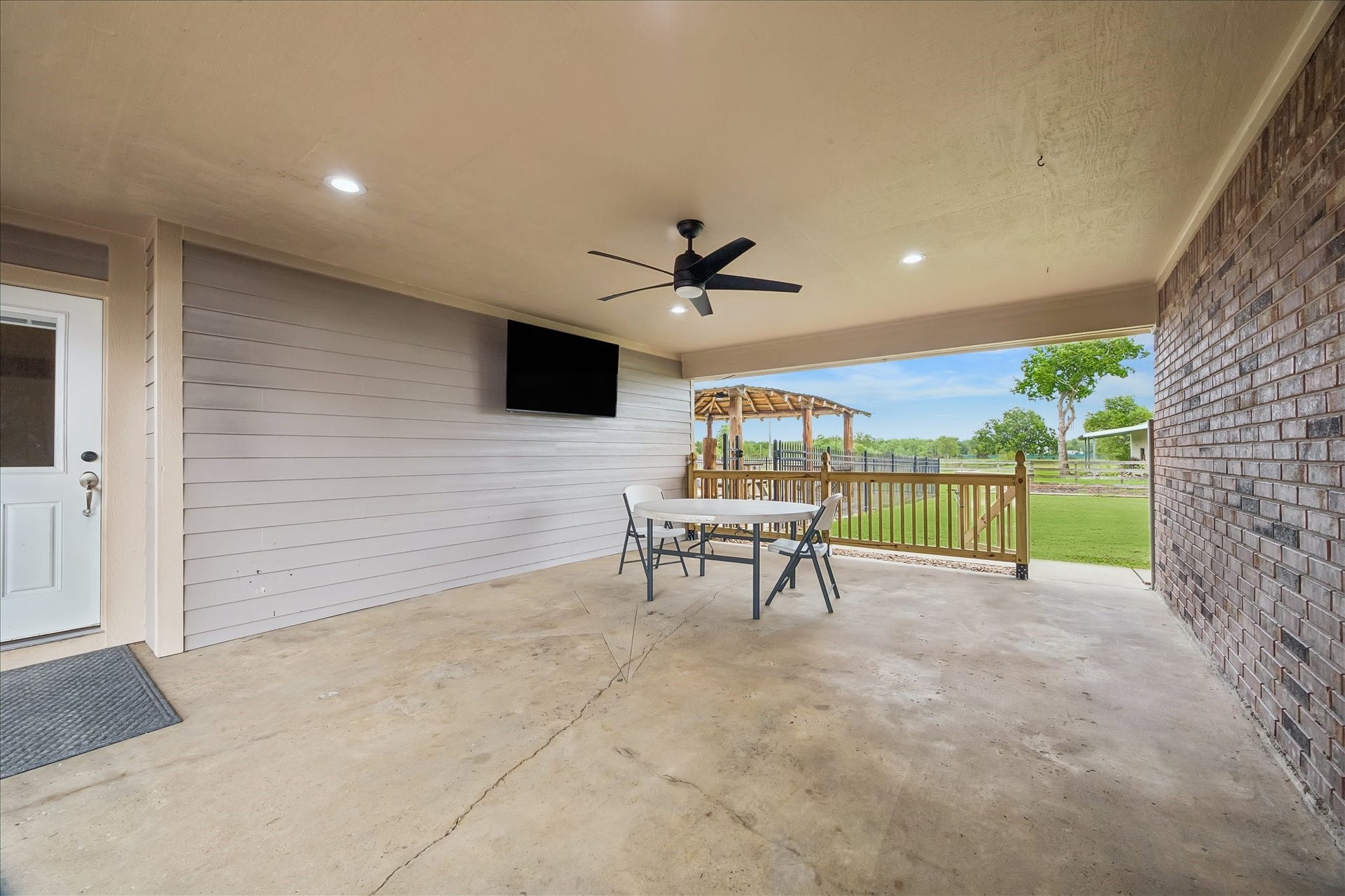 9102 N Humble Camp Road, Dickinson, TX 77539 Breezeway with TV adjoins the house and garage.