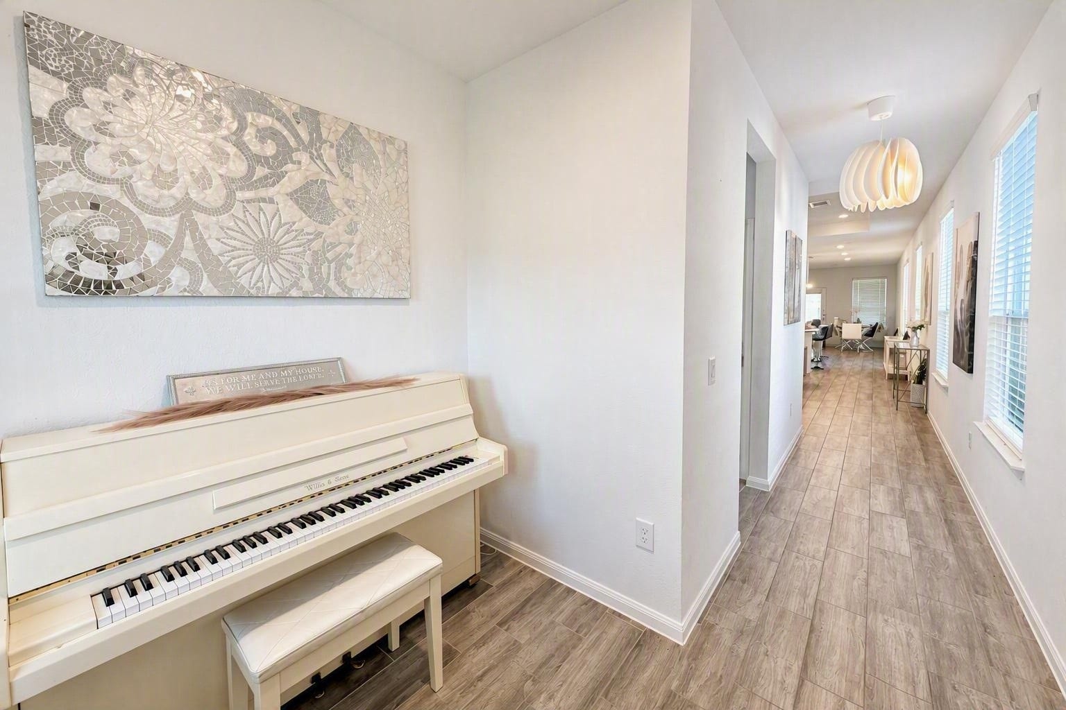 18122 Sonresa Way, Tomball, TX 77377 Bright hallway featuring wood-look flooring, recessed lighting, and a view down the corridor.