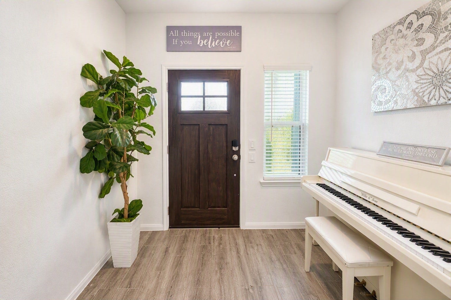 18122 Sonresa Way, Tomball, TX 77377 Bright indoor entryway showcasing wood-look flooring, a welcoming open layout, neutral wall tones, and view toward the interior.