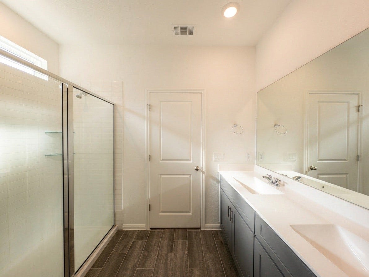18122 Sonresa Way, Tomball, TX 77377 Close-up view of the primary bathroom's walk-in glass-enclosed shower and sleek fixtures.