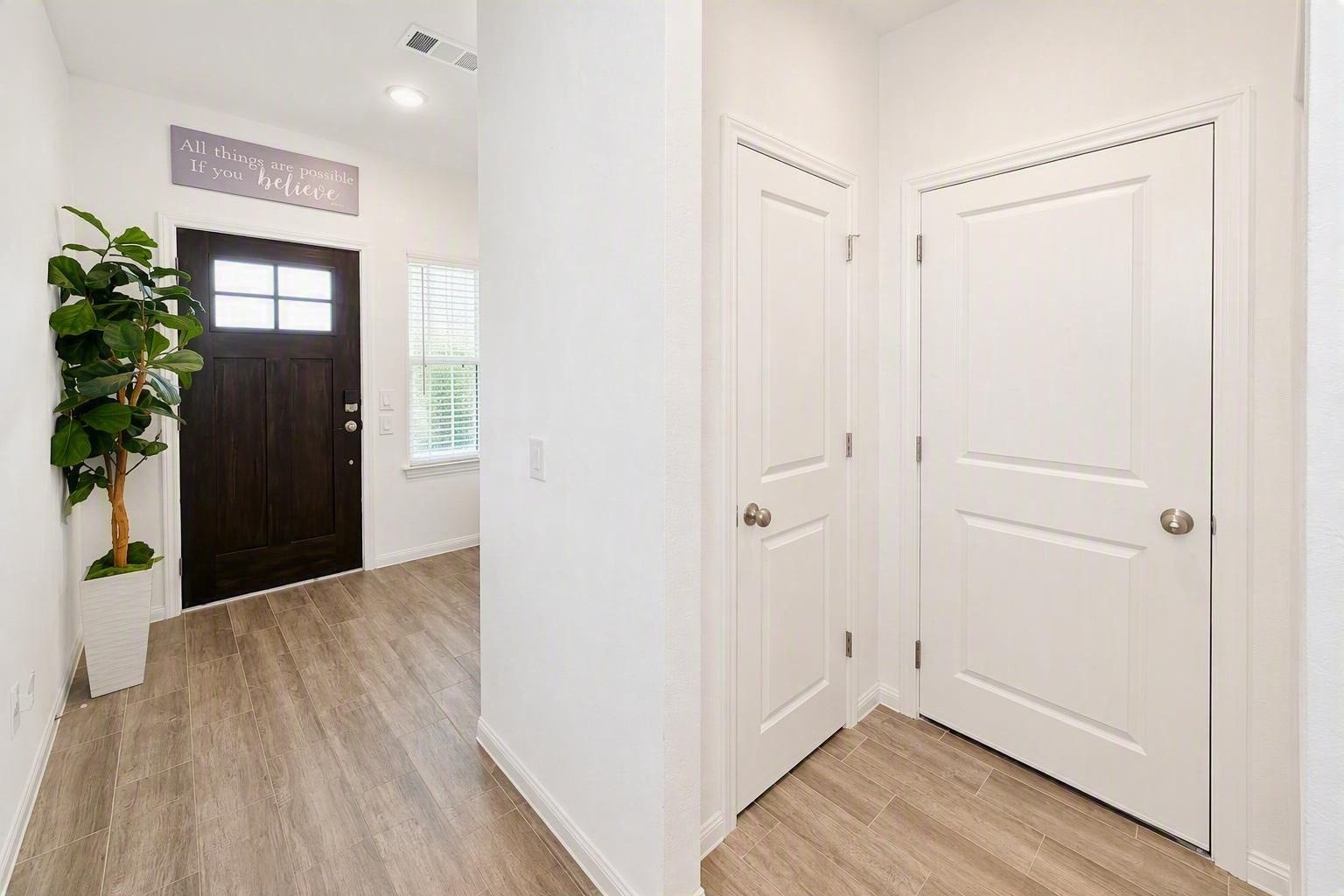 18122 Sonresa Way, Tomball, TX 77377 Interior entryway showing the front door from the inside, light walls, and clean trim work.