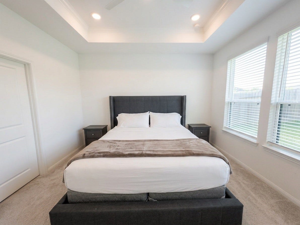 18122 Sonresa Way, Tomball, TX 77377 Alternate perspective of the primary bedroom showcasing the high vaulted ceiling and cozy ambiance.