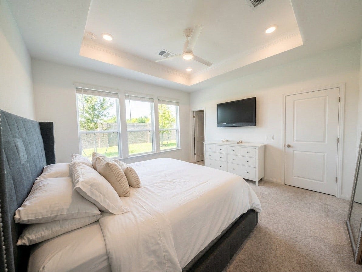18122 Sonresa Way, Tomball, TX 77377 Alternate view of the spacious primary bedroom highlighting its neutral color scheme and generous layout.