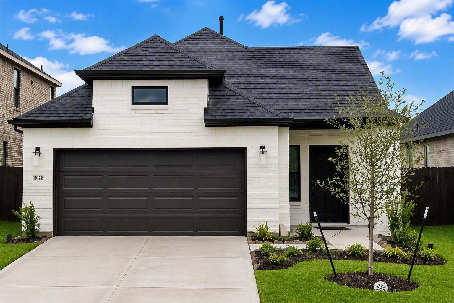 18122 Sonresa Way, Tomball, TX 77377 Street-level front elevation showcasing the modern architectural design, driveway, and neighborhood surroundings.