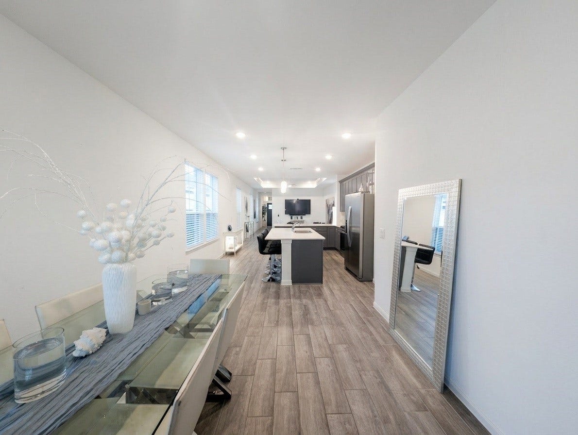 18122 Sonresa Way, Tomball, TX 77377 Wide corridor view showing the continuous flooring, recessed lighting, and seamless room transitions.