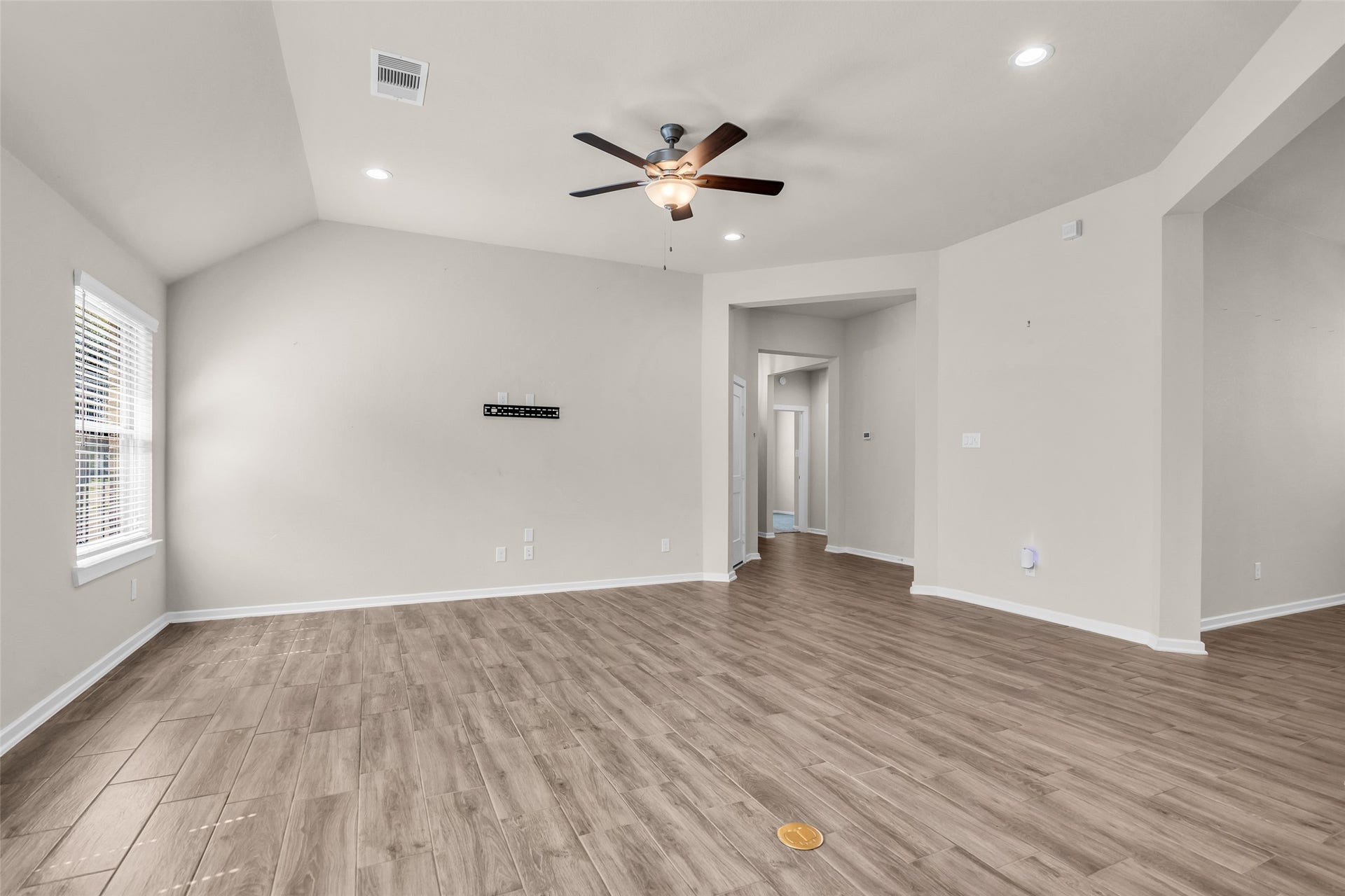 11935 Radura Road, Humble, TX 77346 Bright, open-concept living room with lots of natural light an seamless flow into the kitchen.