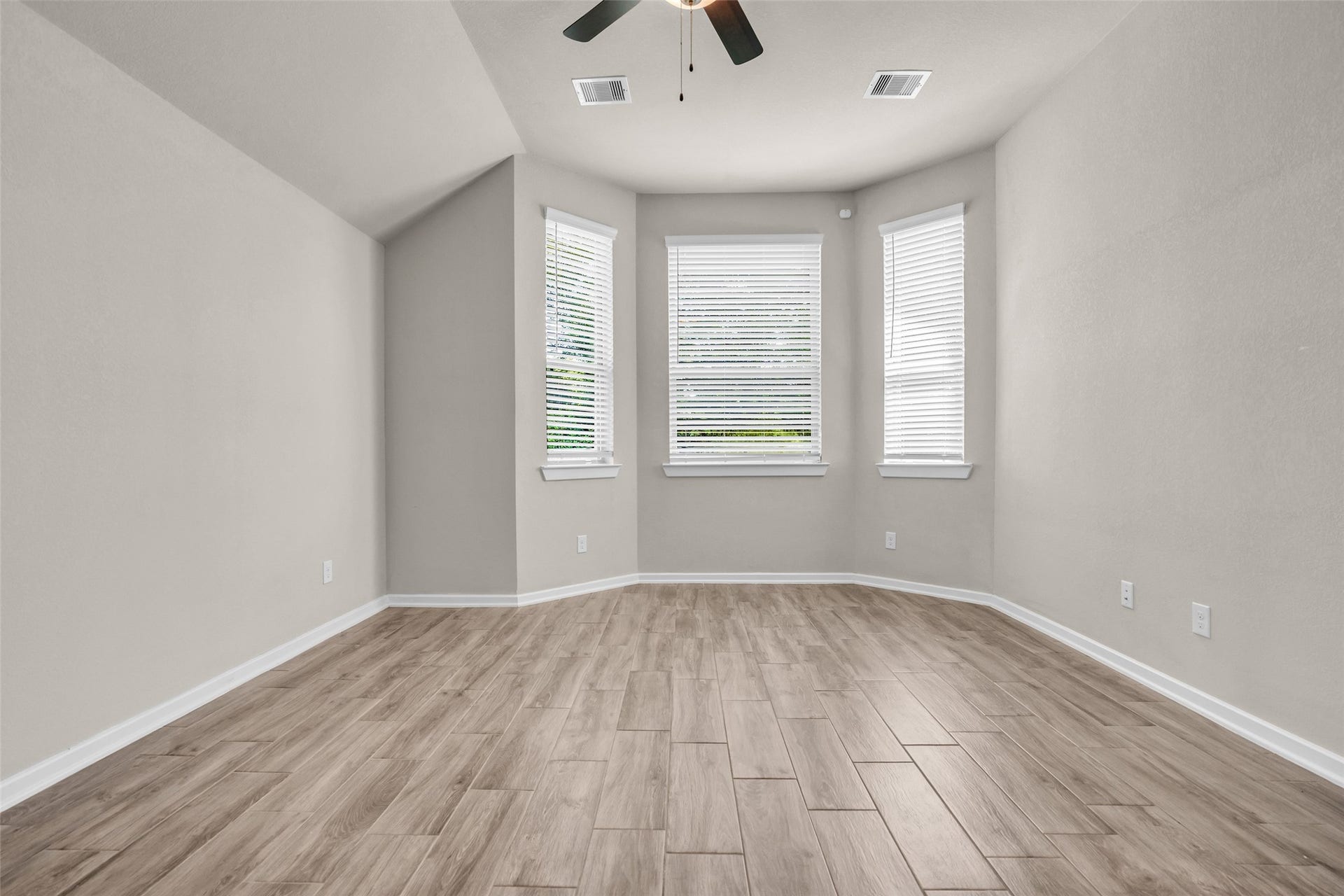 11935 Radura Road, Humble, TX 77346 Spacious primary bedroom with large windows and peaceful retreat atmosphere