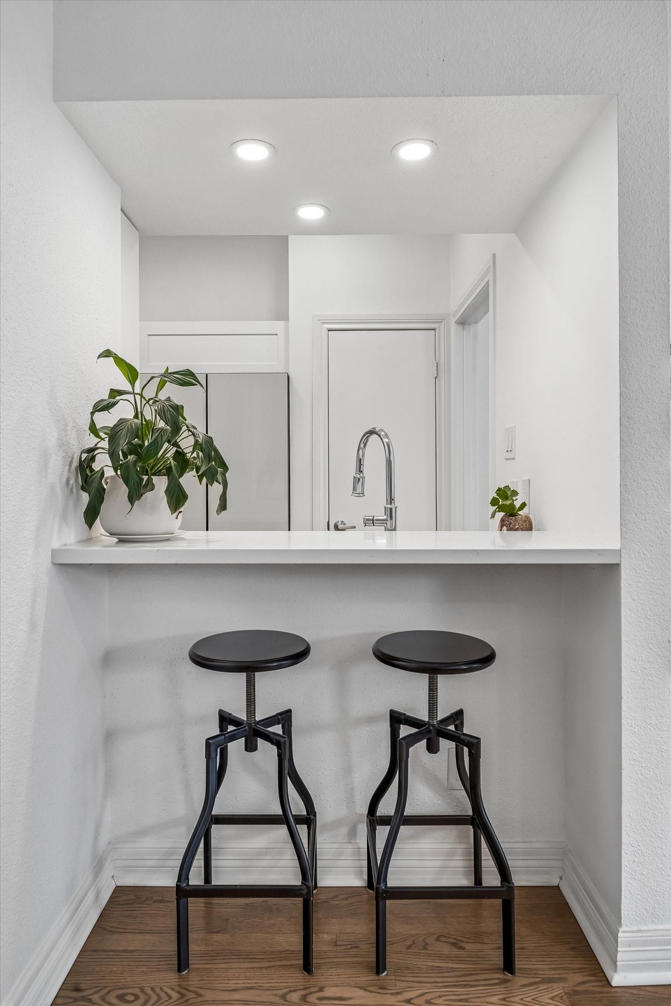 Chic breakfast bar with modern lighting, and a minimalist vibe, perfect for casual dining or entertaining.