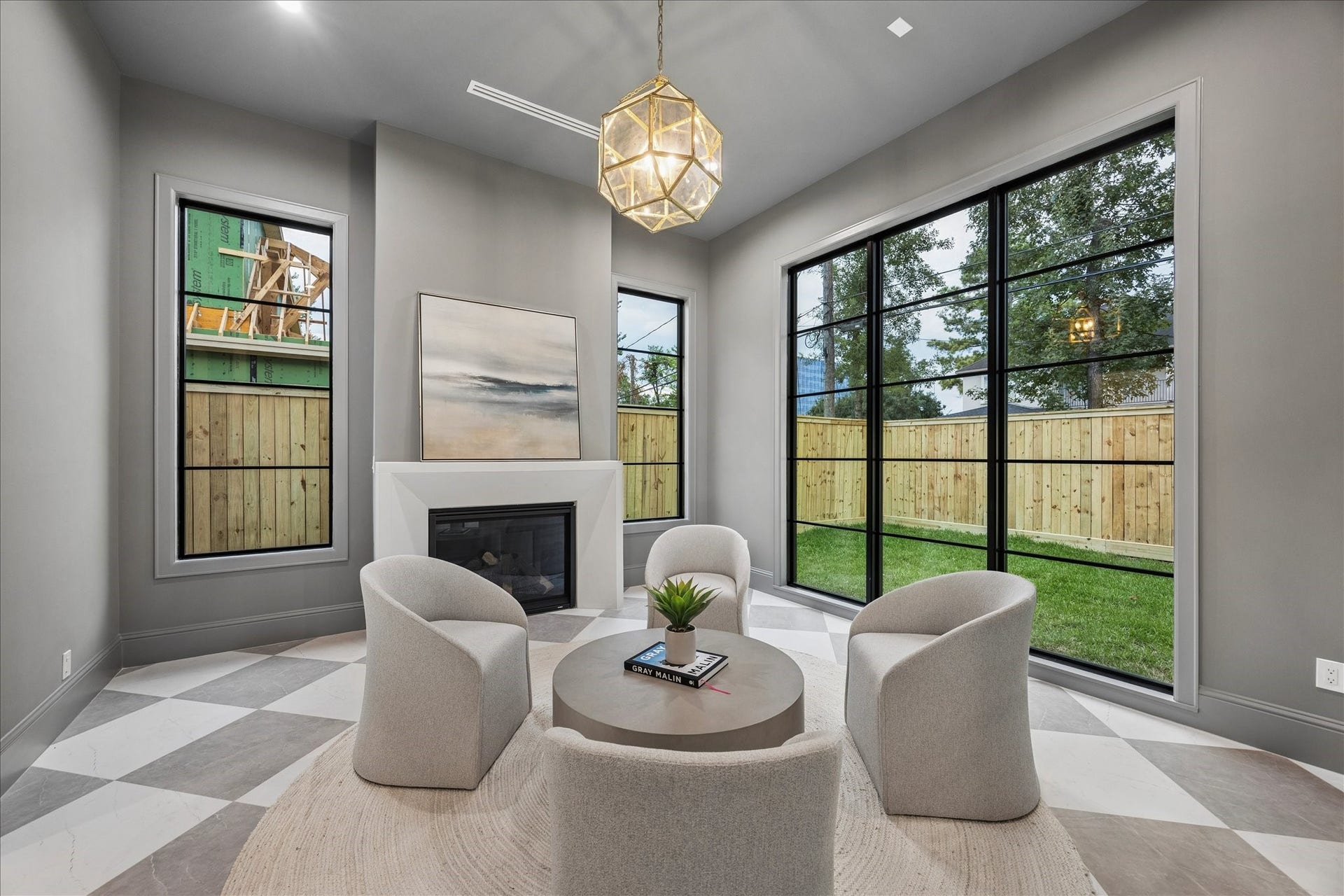 7719 Bryonwood Drive, Houston, TX 77055 The keeping room off the kitchen pairs a gas fireplace with checkerboard tile and tall windows.