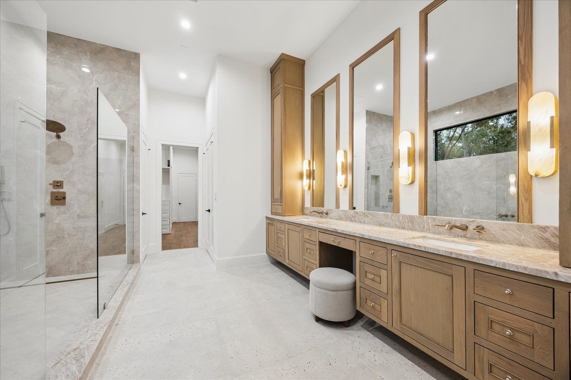 7719 Bryonwood Drive, Houston, TX 77055 The primary bath has dual vanities, a built-in makeup station, and rich oak cabinetry.