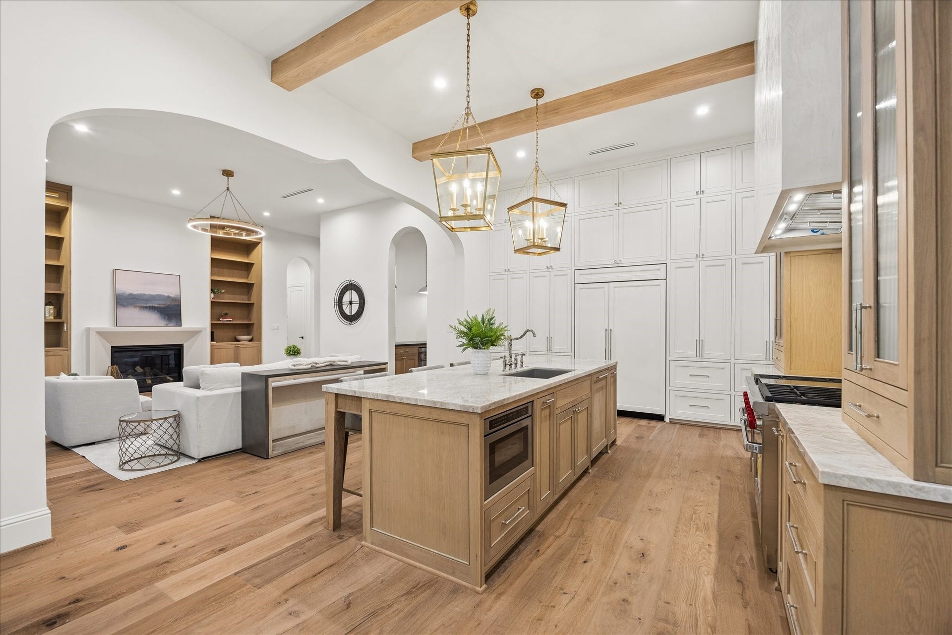 7719 Bryonwood Drive, Houston, TX 77055 Beamed ceilings and arched openings tie the kitchen to the living spaces.