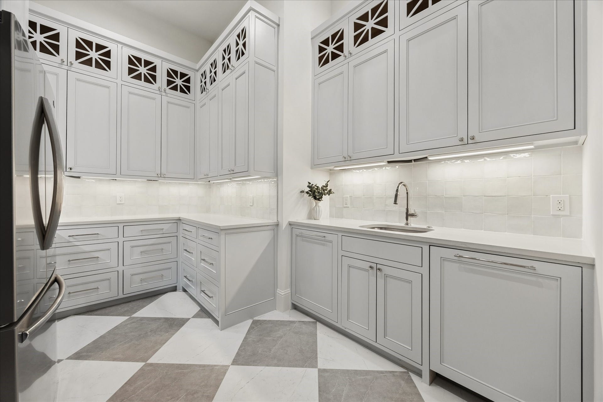 7719 Bryonwood Drive, Houston, TX 77055 Behind the kitchen, the scullery adds a second sink, a second refrigerator, and checkerboard tile floors.