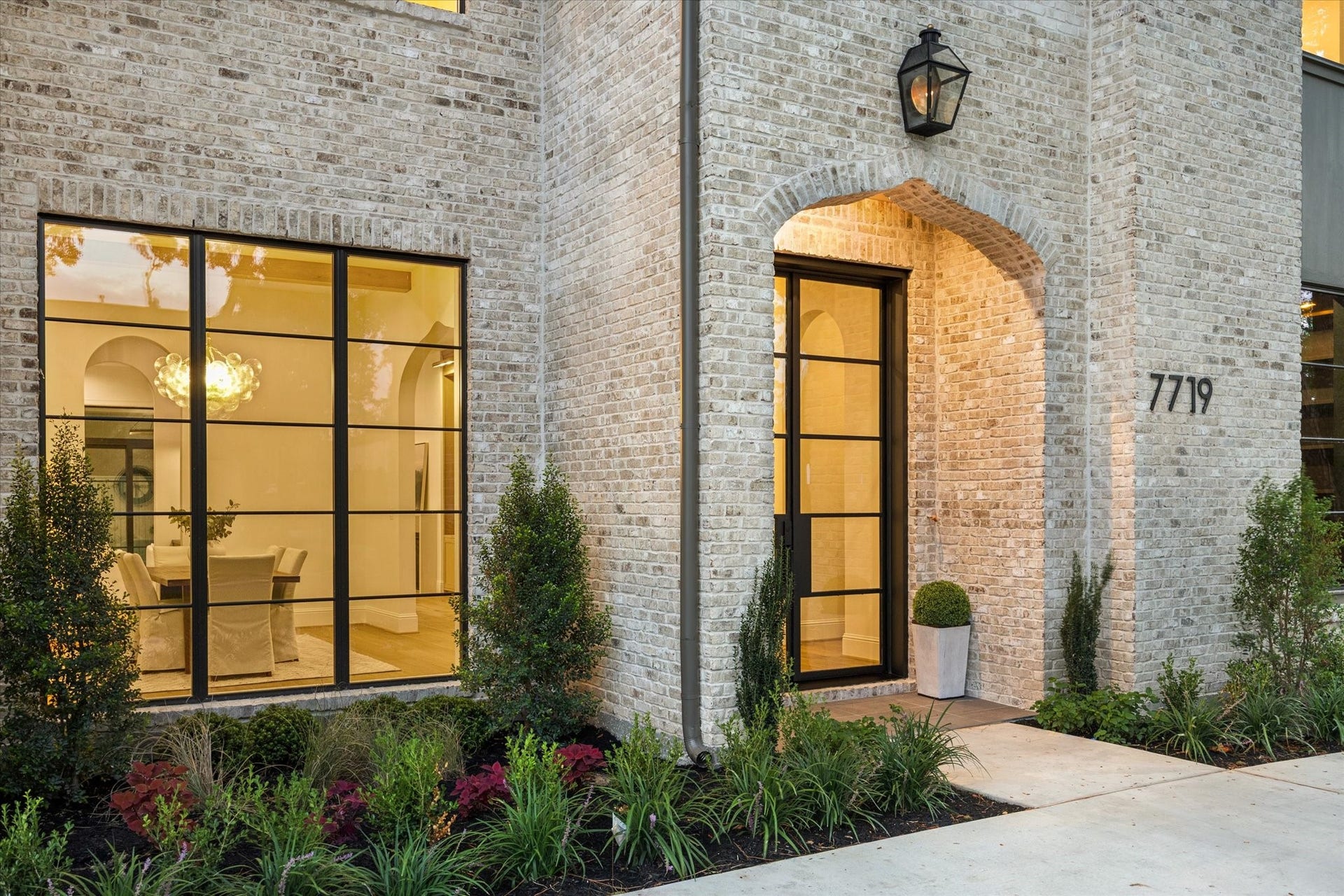 7719 Bryonwood Drive, Houston, TX 77055 A lantern-lit arched brick entry wrapped in lush landscaping.