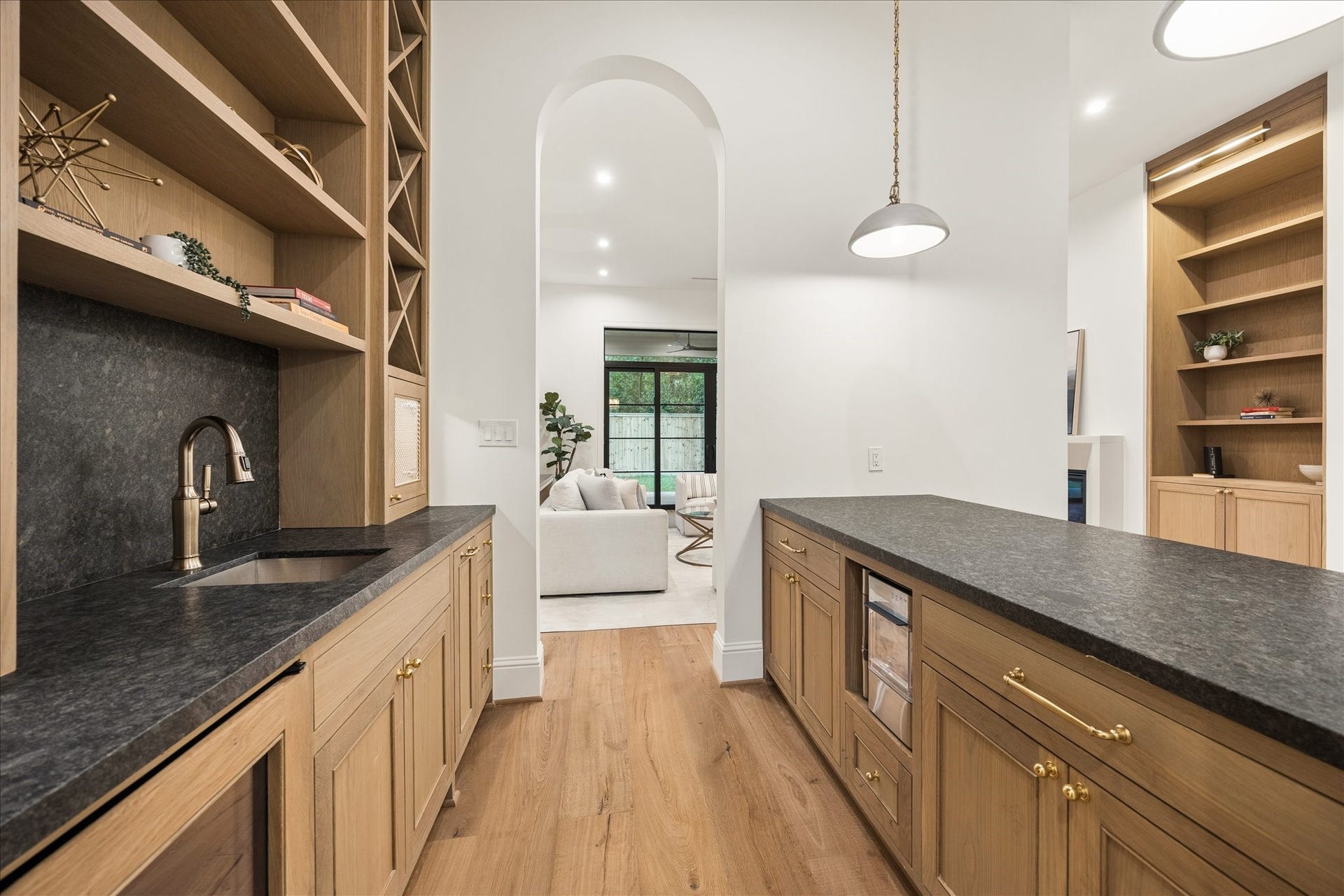 7719 Bryonwood Drive, Houston, TX 77055 The butler's pantry links kitchen and dining with a wet bar, wine storage, and oak cabinetry.