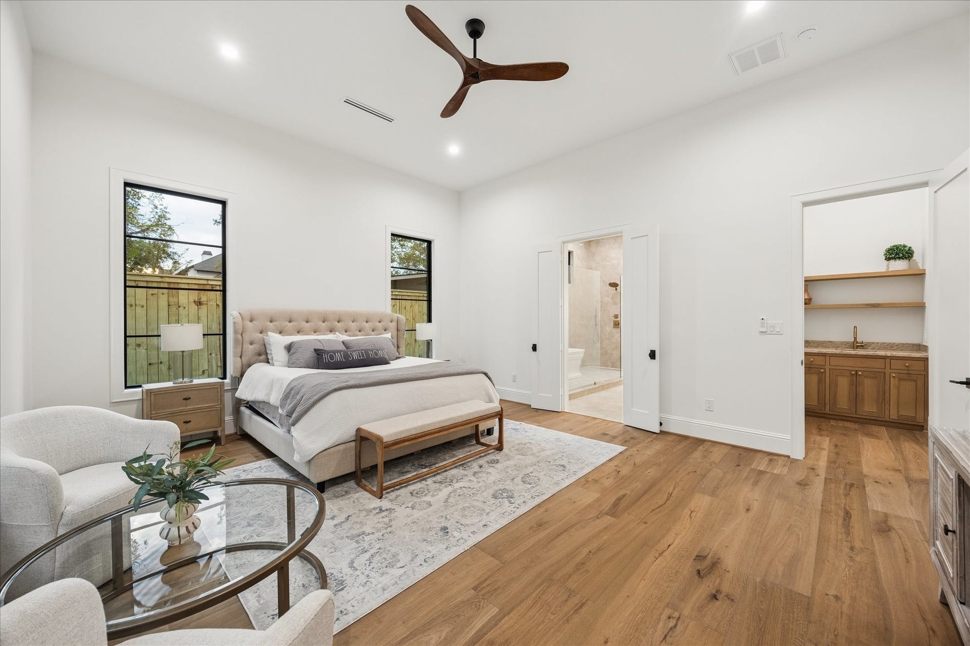 7719 Bryonwood Drive, Houston, TX 77055 Wide-plank oak floors carry through the primary bedroom, with direct access to the spa bath.